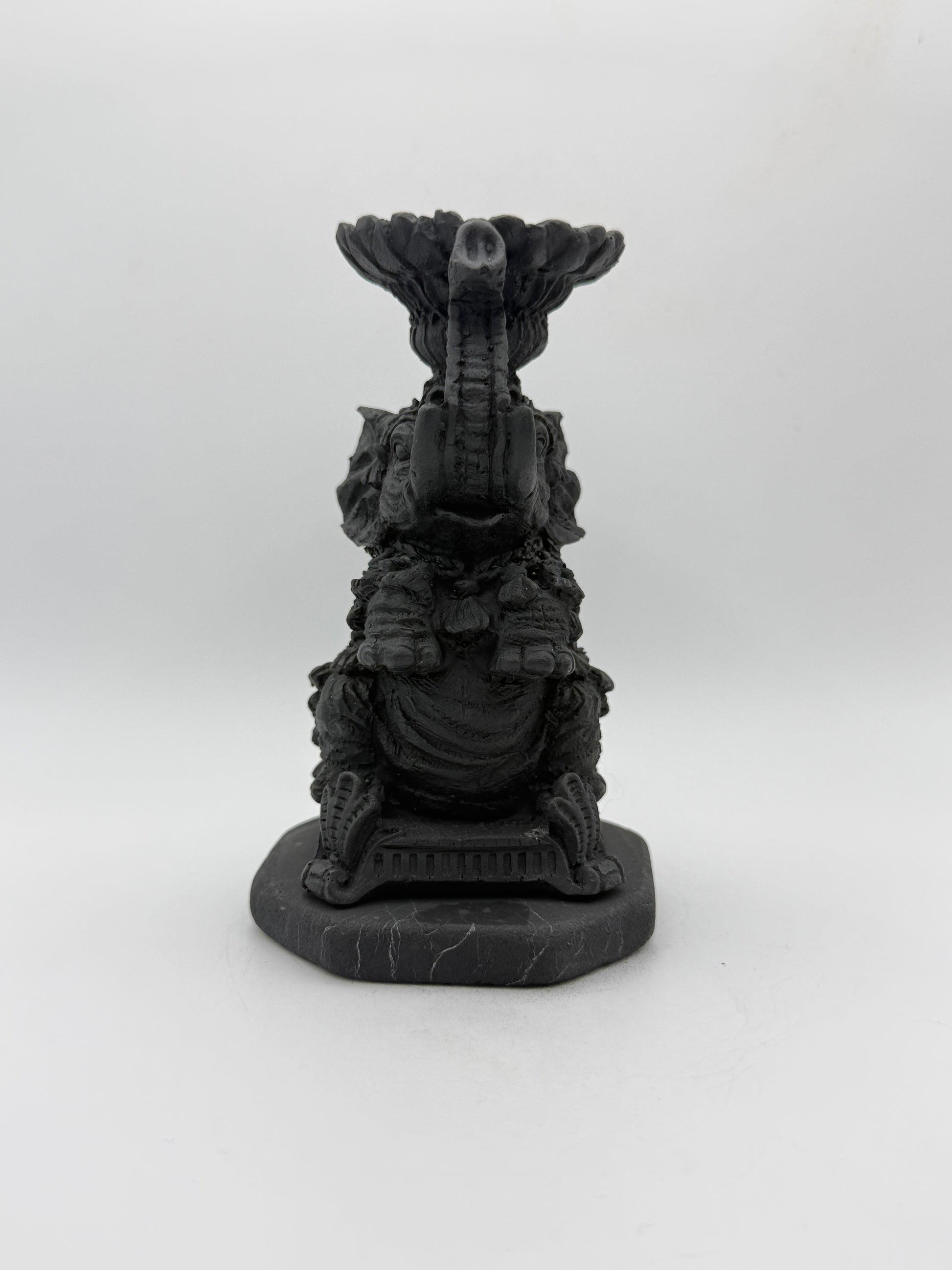 Shungite carving of an elephant that can be used as a candle holder.