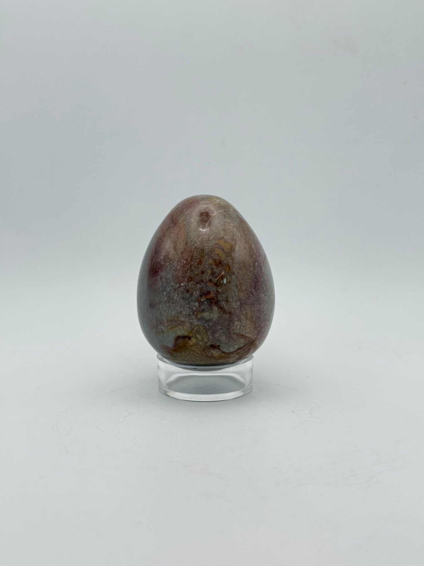 Polished polychrome jasper shaped into an egg.