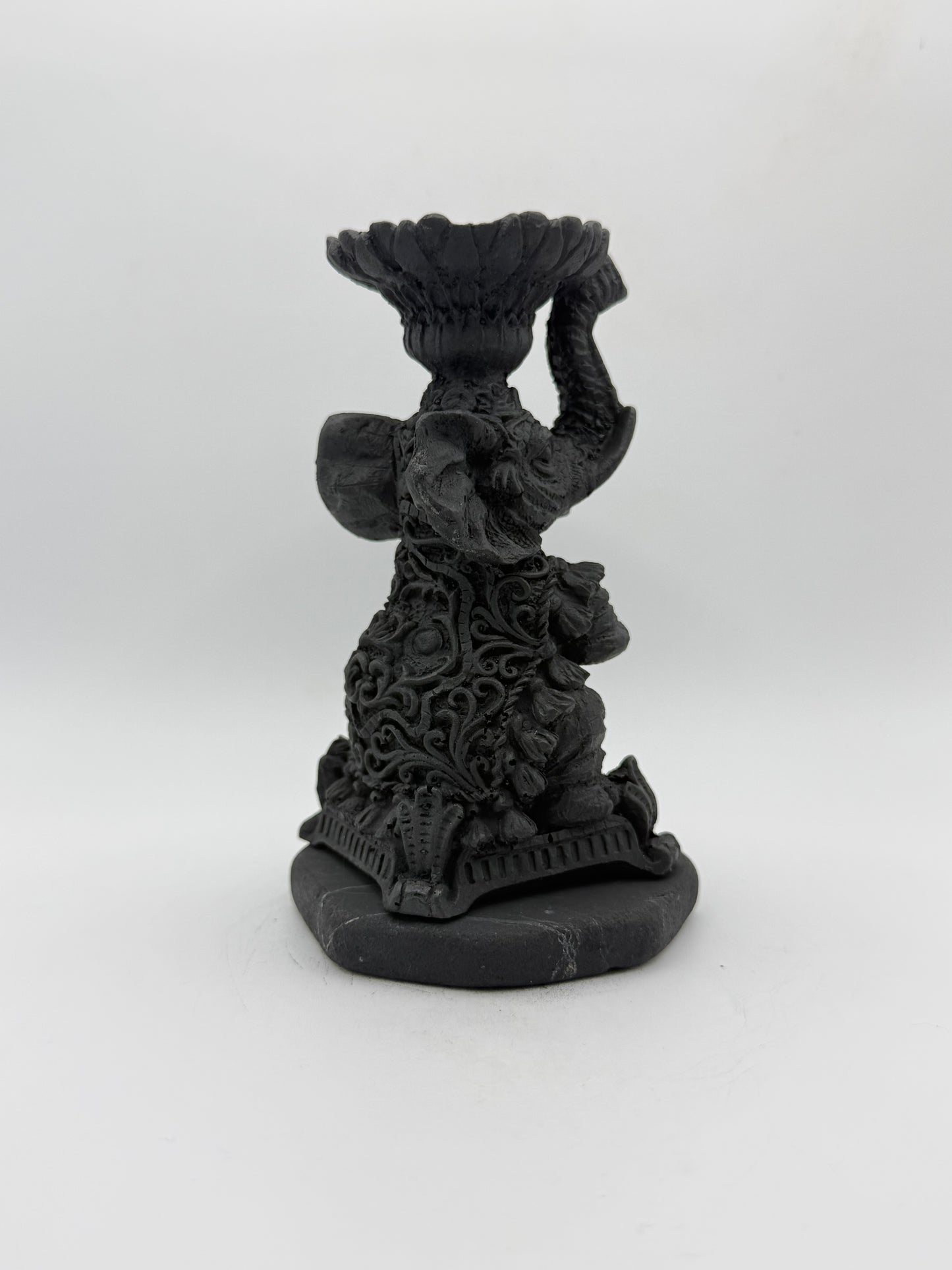 Shungite carving of an elephant that can be used as a candle holder.