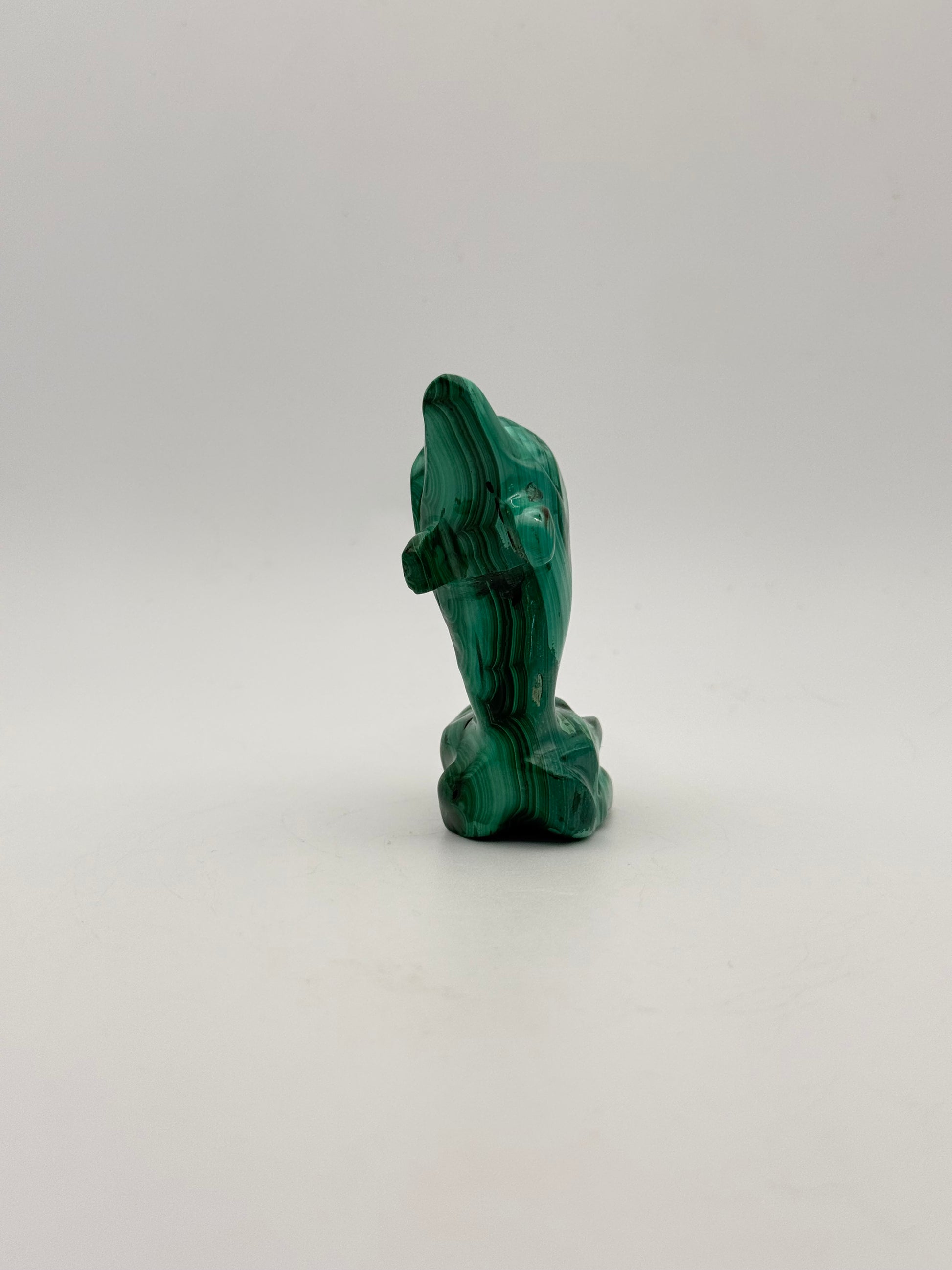 Polished malachite dolphin carving.