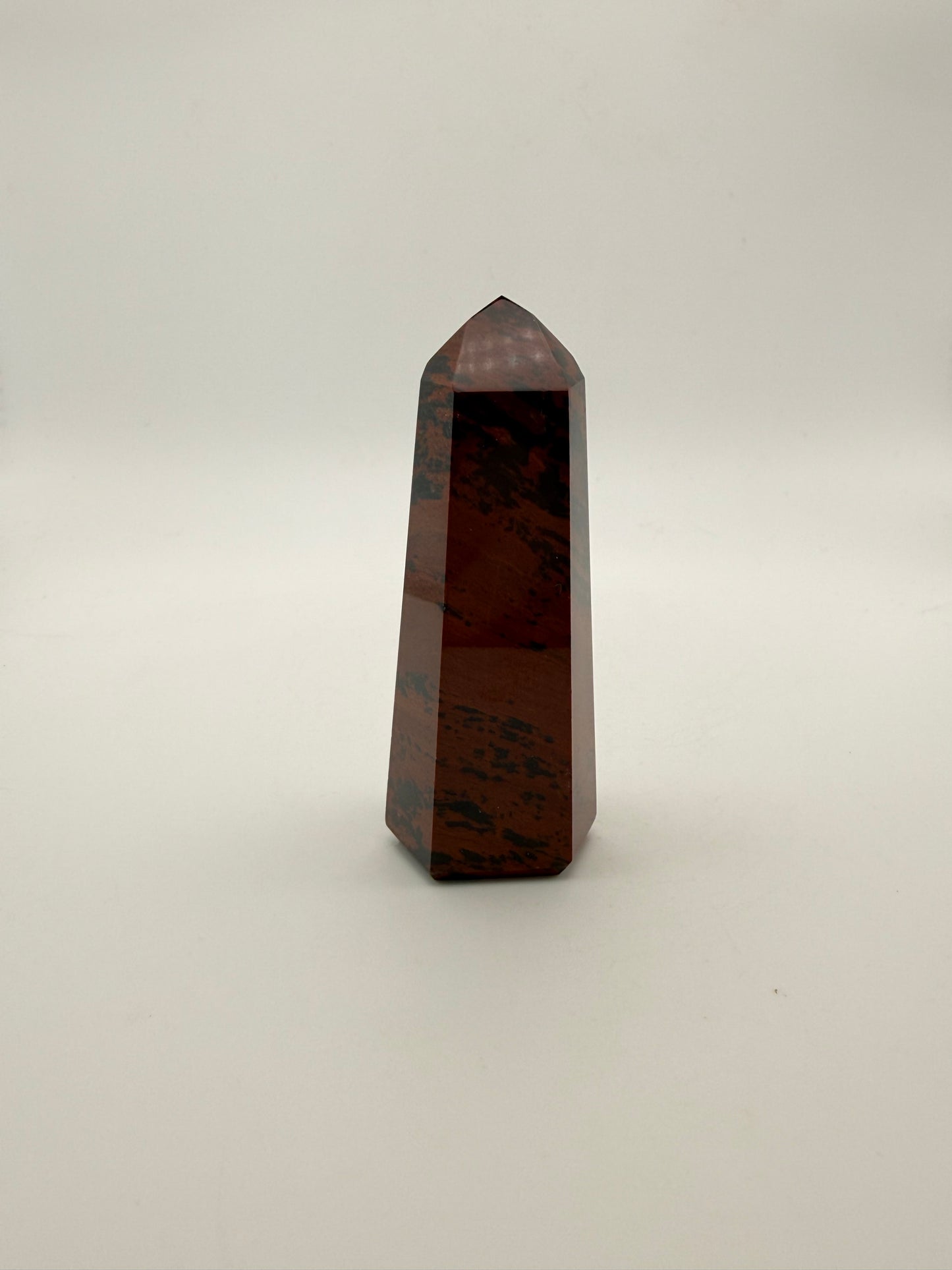 Polished mahogany obsidian tower with six sides.