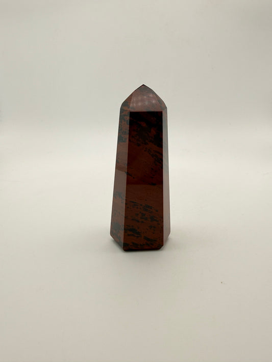 Polished mahogany obsidian tower with six sides.