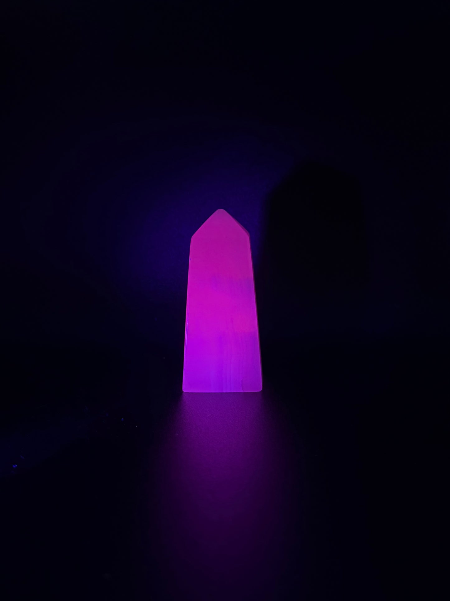 Polished pink calcite tower. Pink calcite glows under uv light.