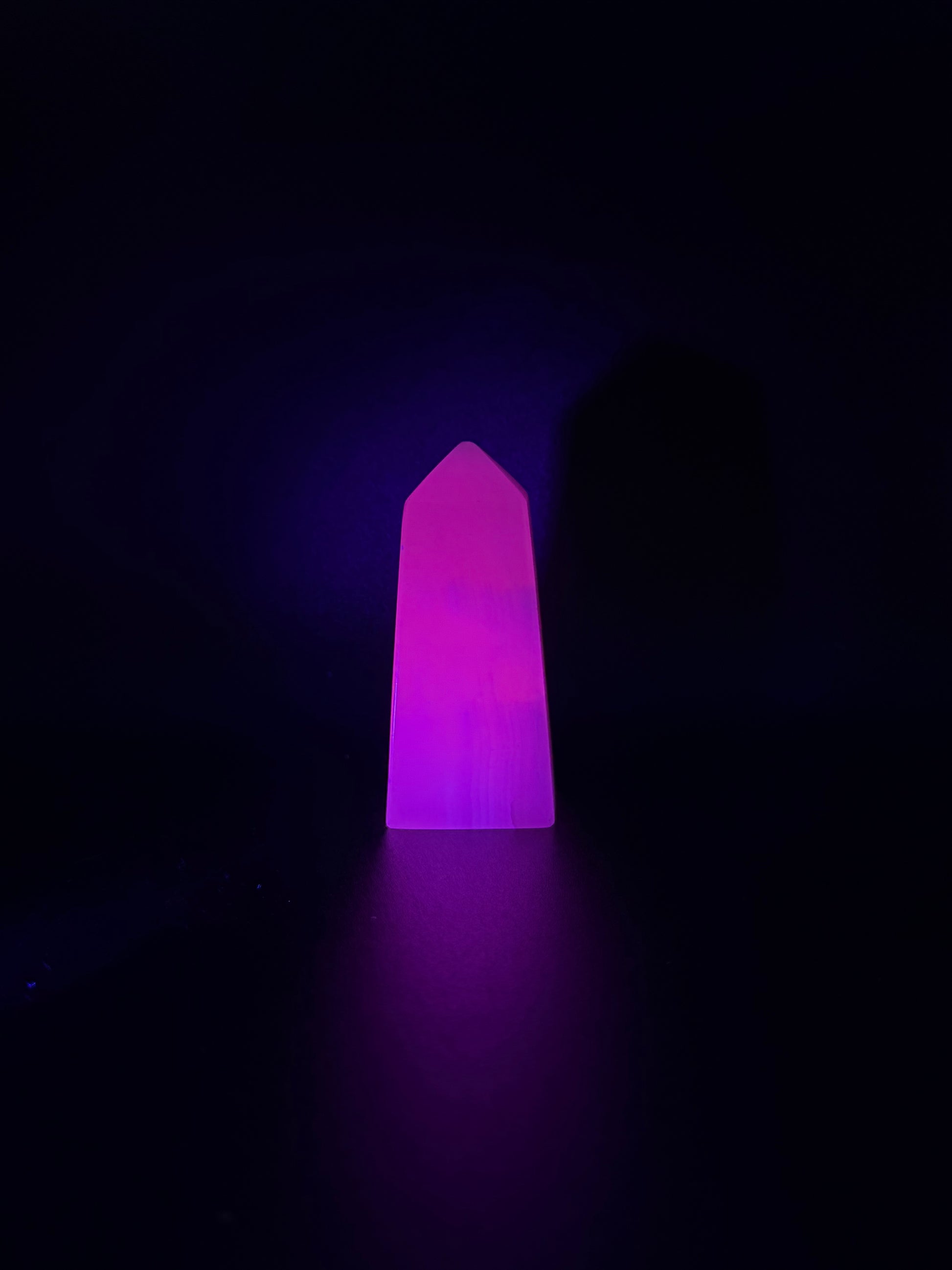 Polished pink calcite tower. Pink calcite glows under uv light.