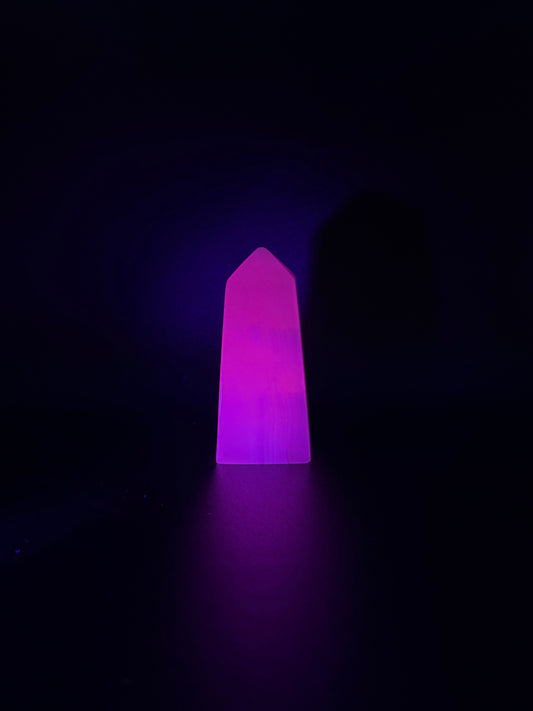 Polished pink calcite tower. Pink calcite glows under uv light.