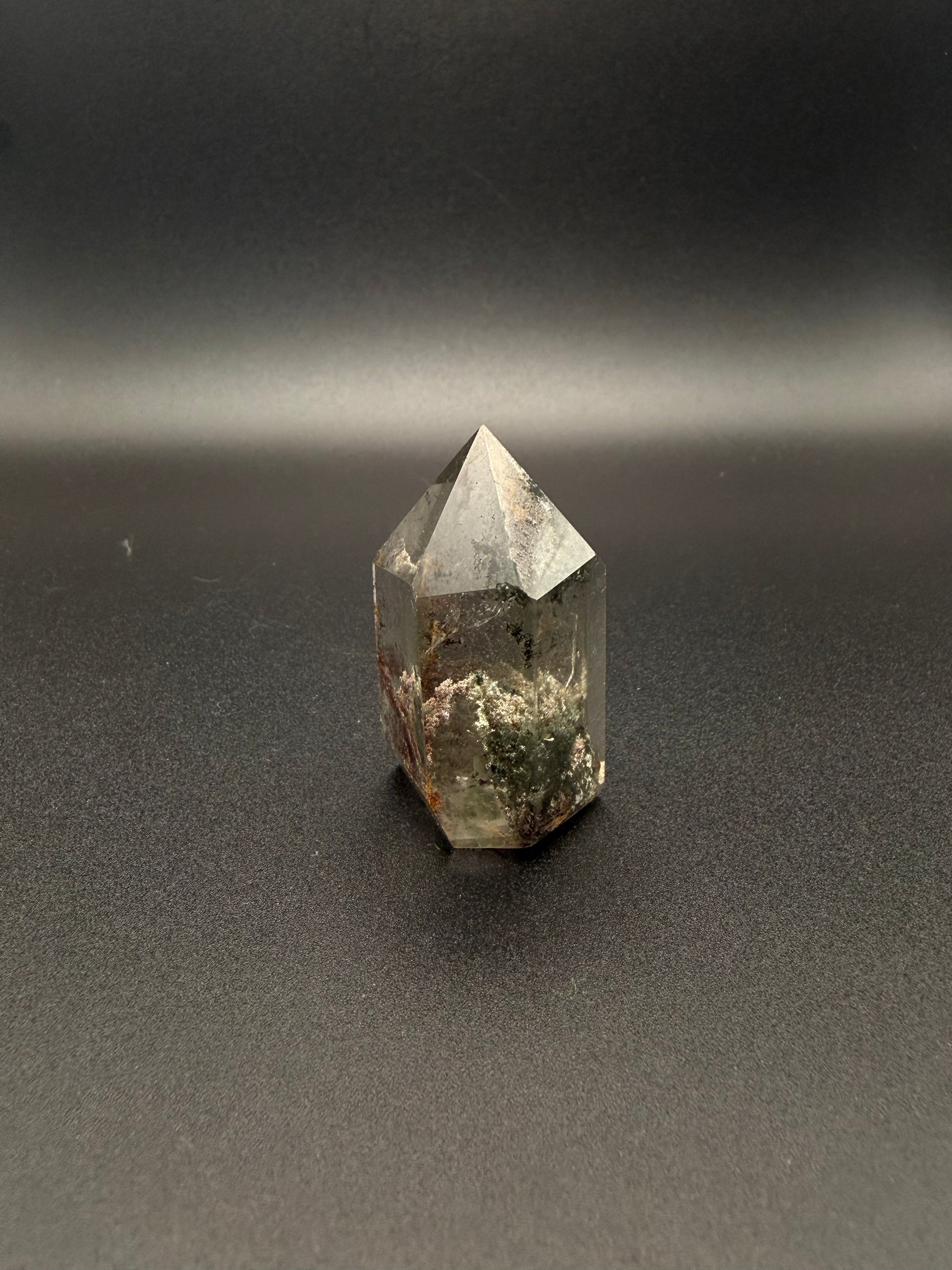 Polished garden quartz crystal tower with six sides.