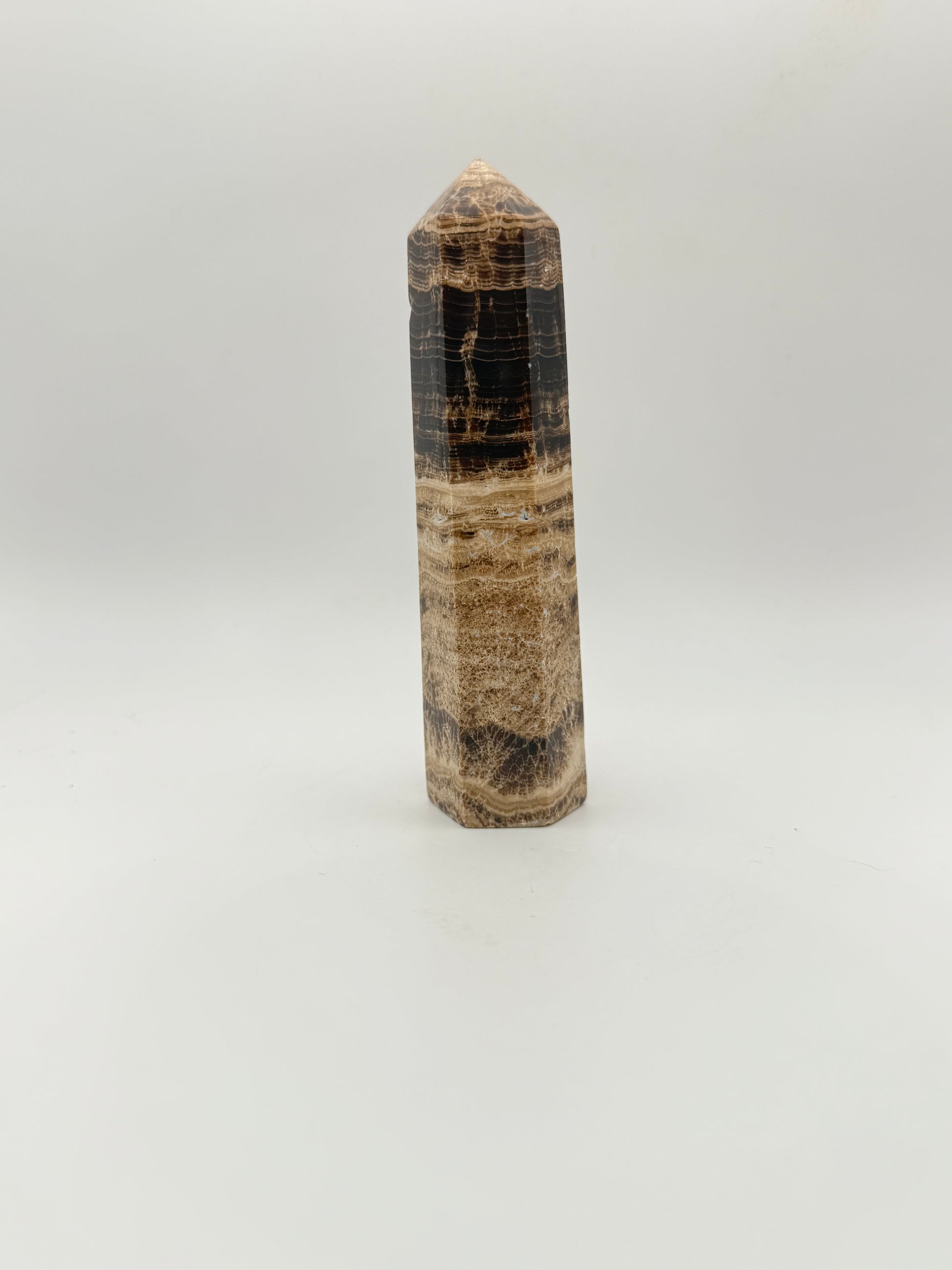 Polished chocolate calcite crystal tower. about 5 inches tall.