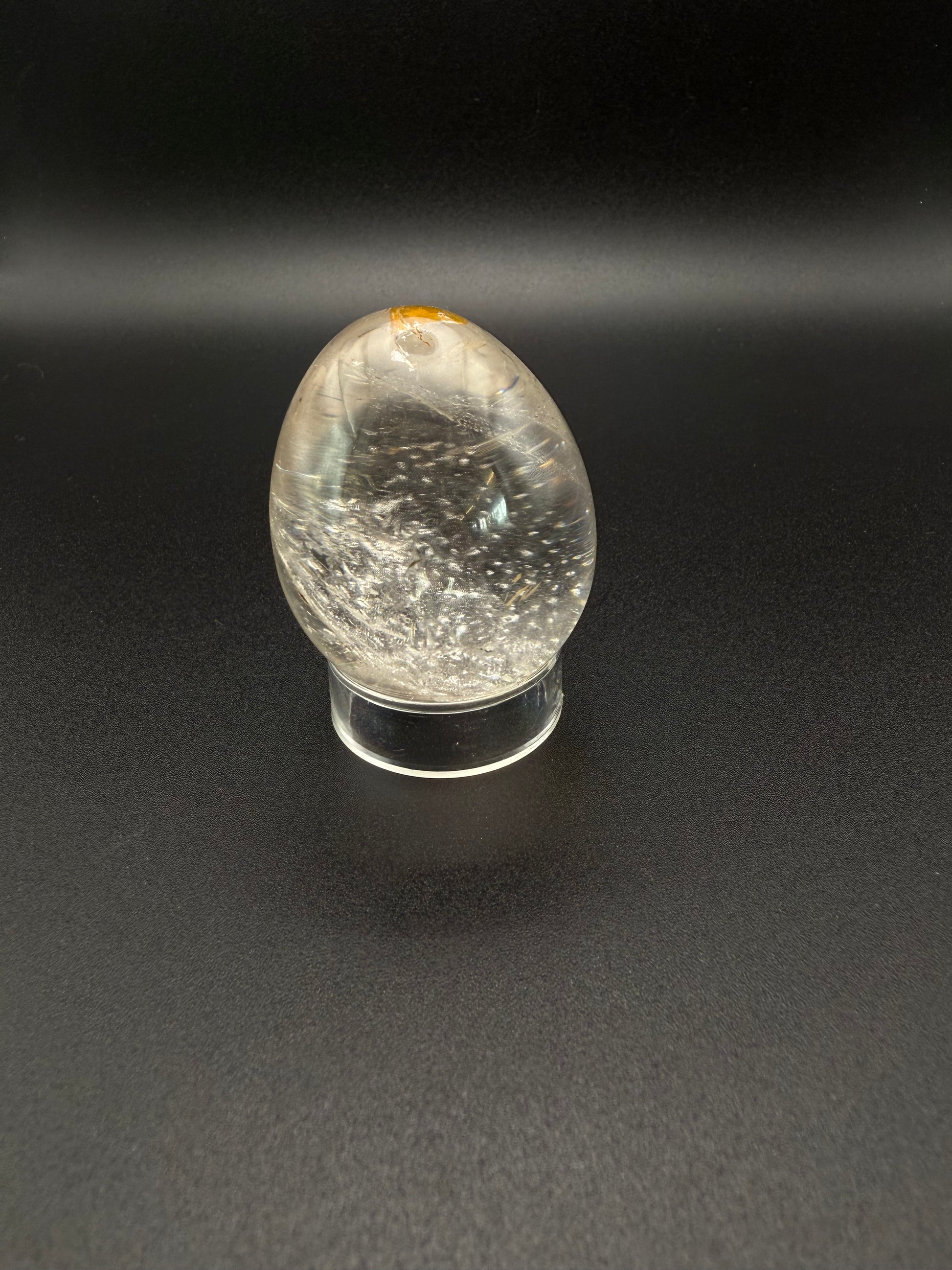 Clear quartz polished crystal thats egg shaped.