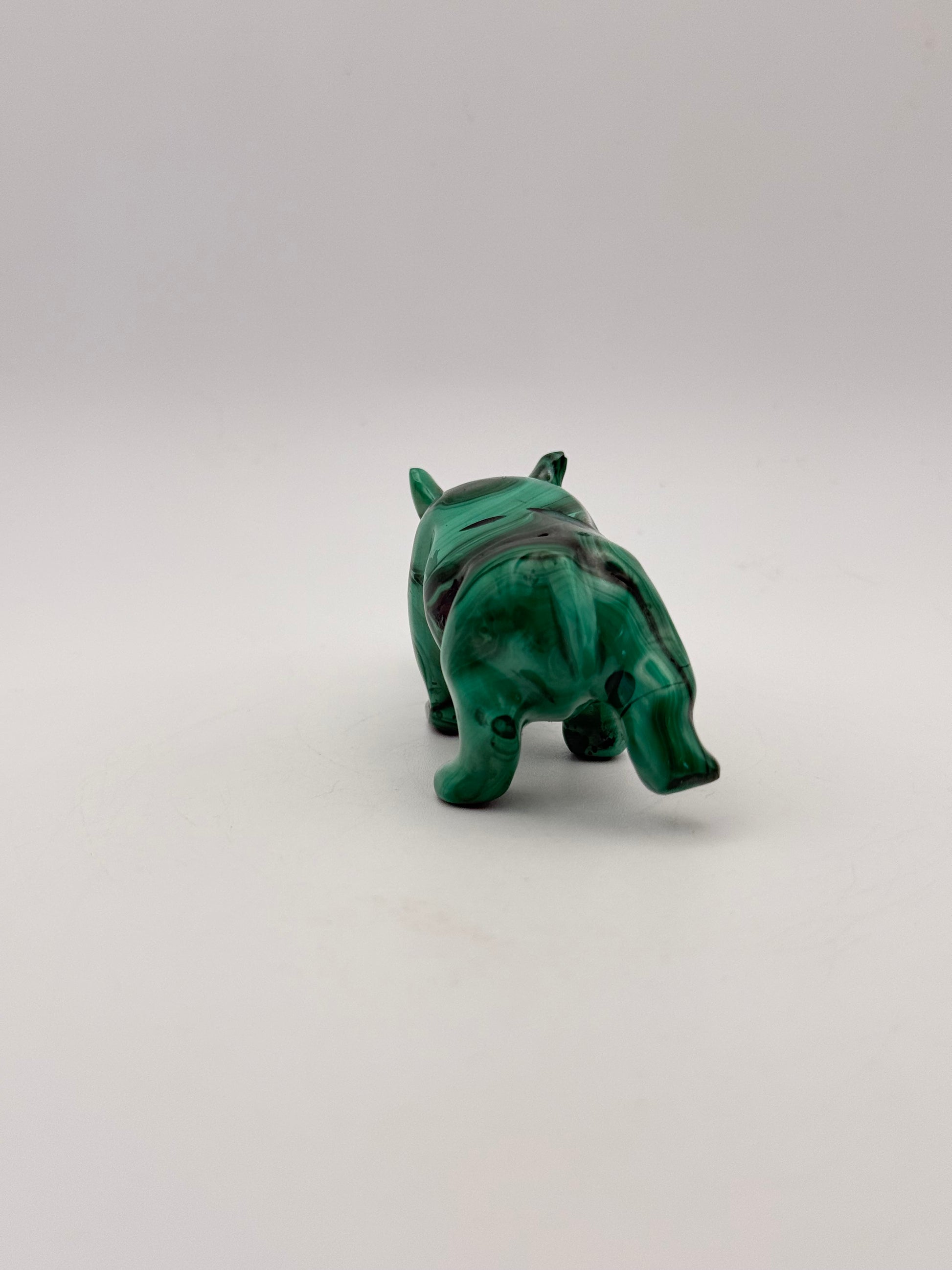 Vibrant green malachite carving of a rhino.