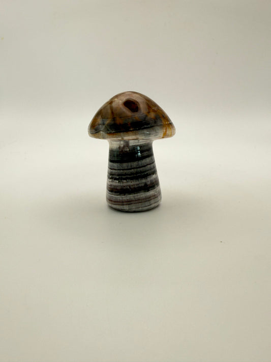 Polished chocolate calcite crystal shaped into a mushroom.
