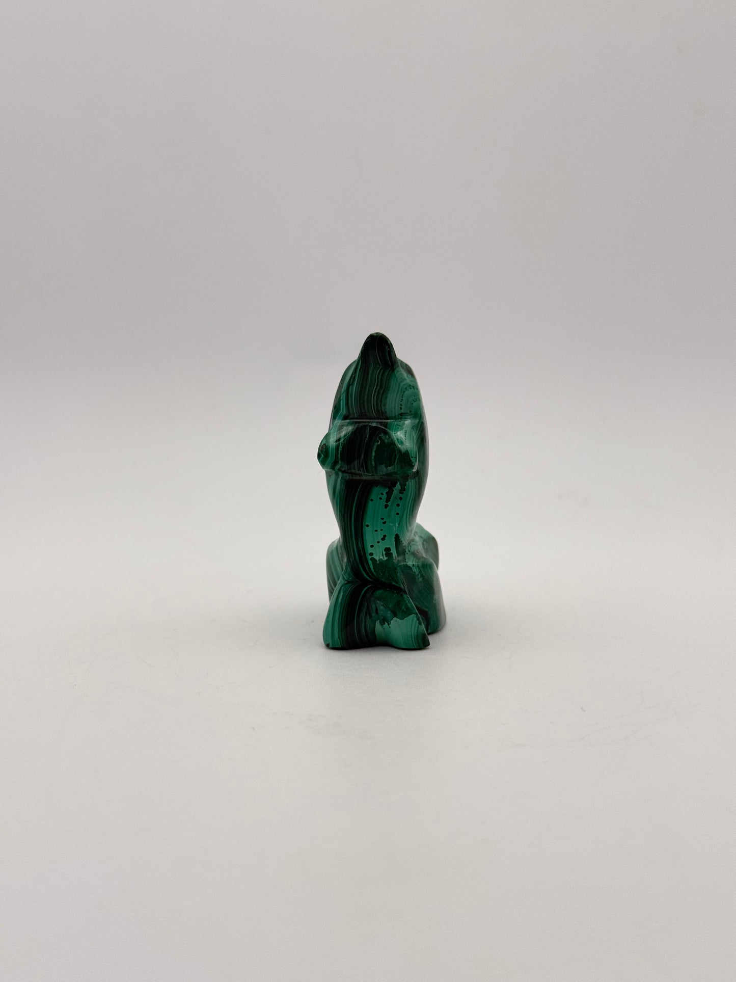 Polished malachite dolphin carving.
