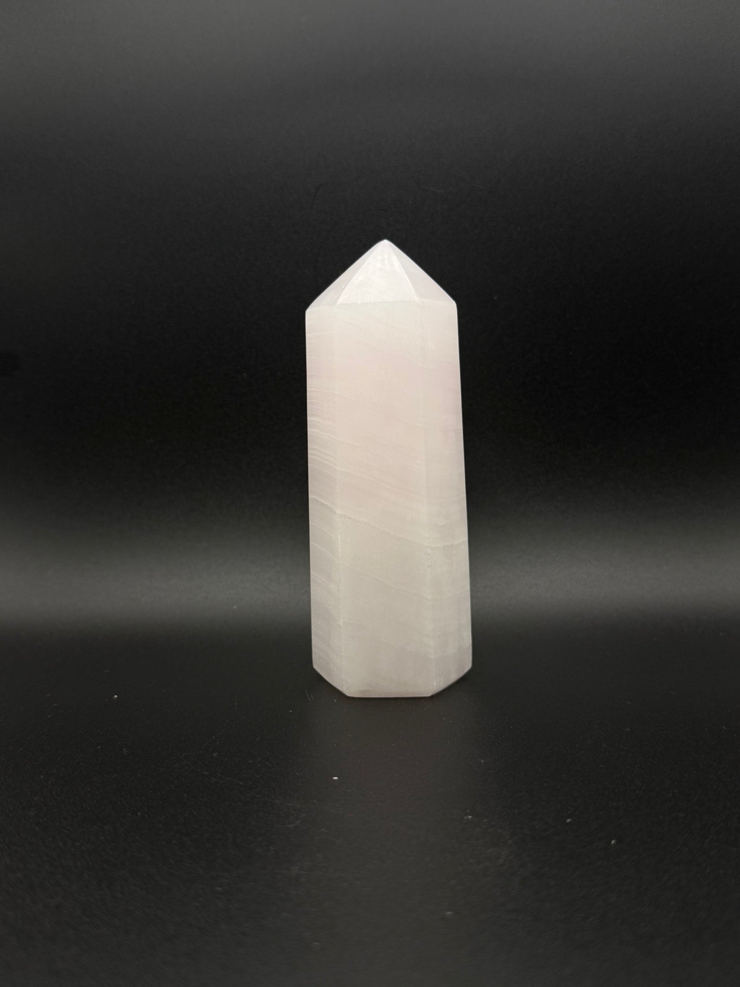 Polished pink calcite tower. Pink calcite glows under uv light.