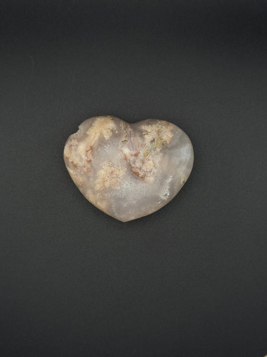 Heart-shaped polished flower agate crystal.