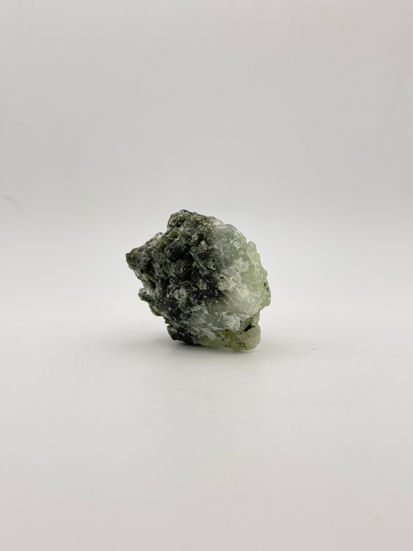 Raw Prehnite specimen with amazing green color.