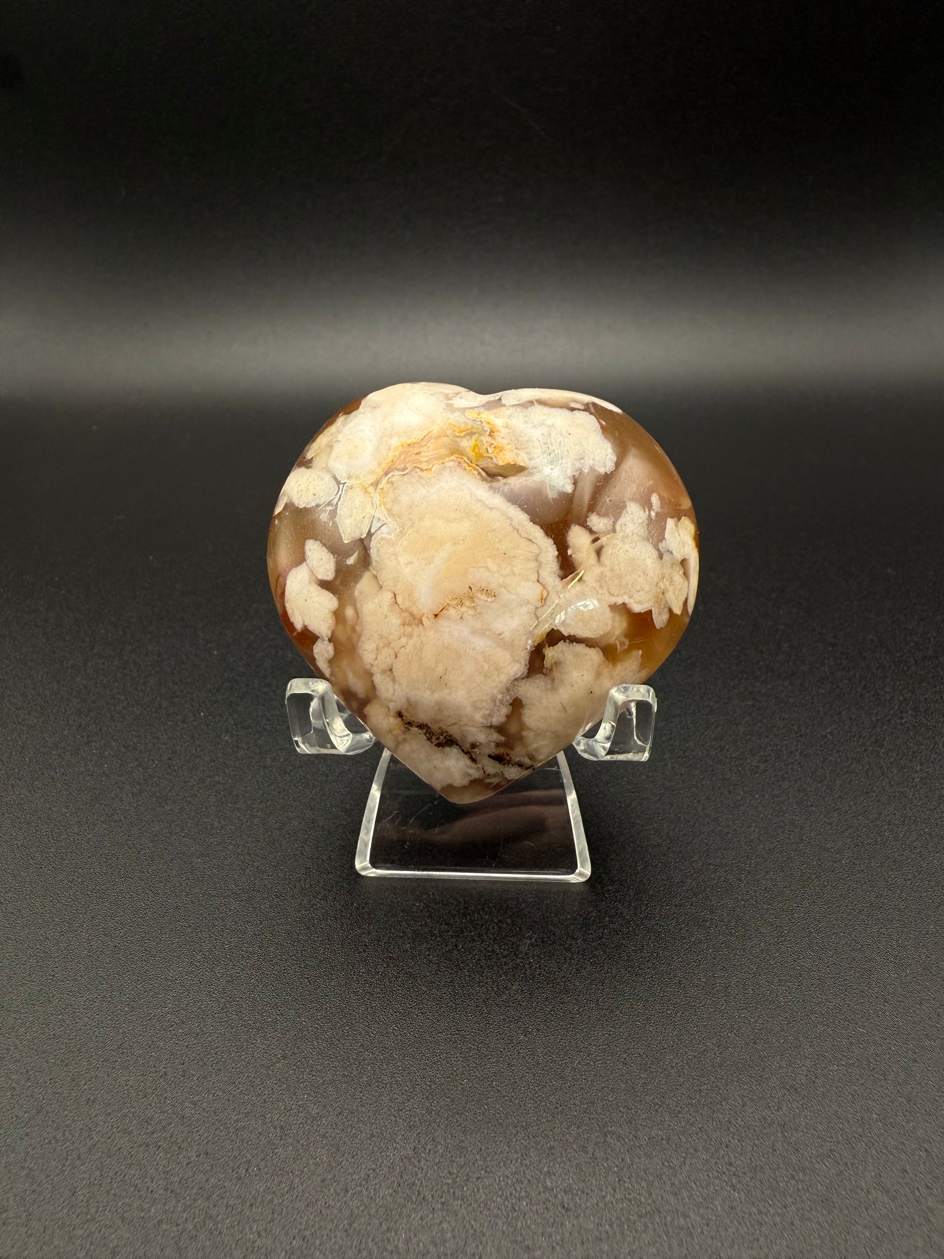 Flower Agate polished crystal in the shape of a heart.