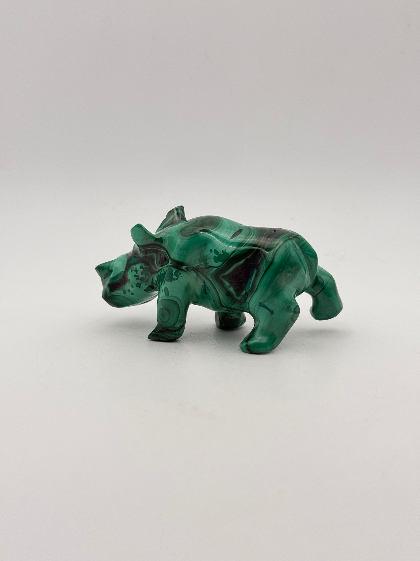 Vibrant green malachite carving of a rhino.