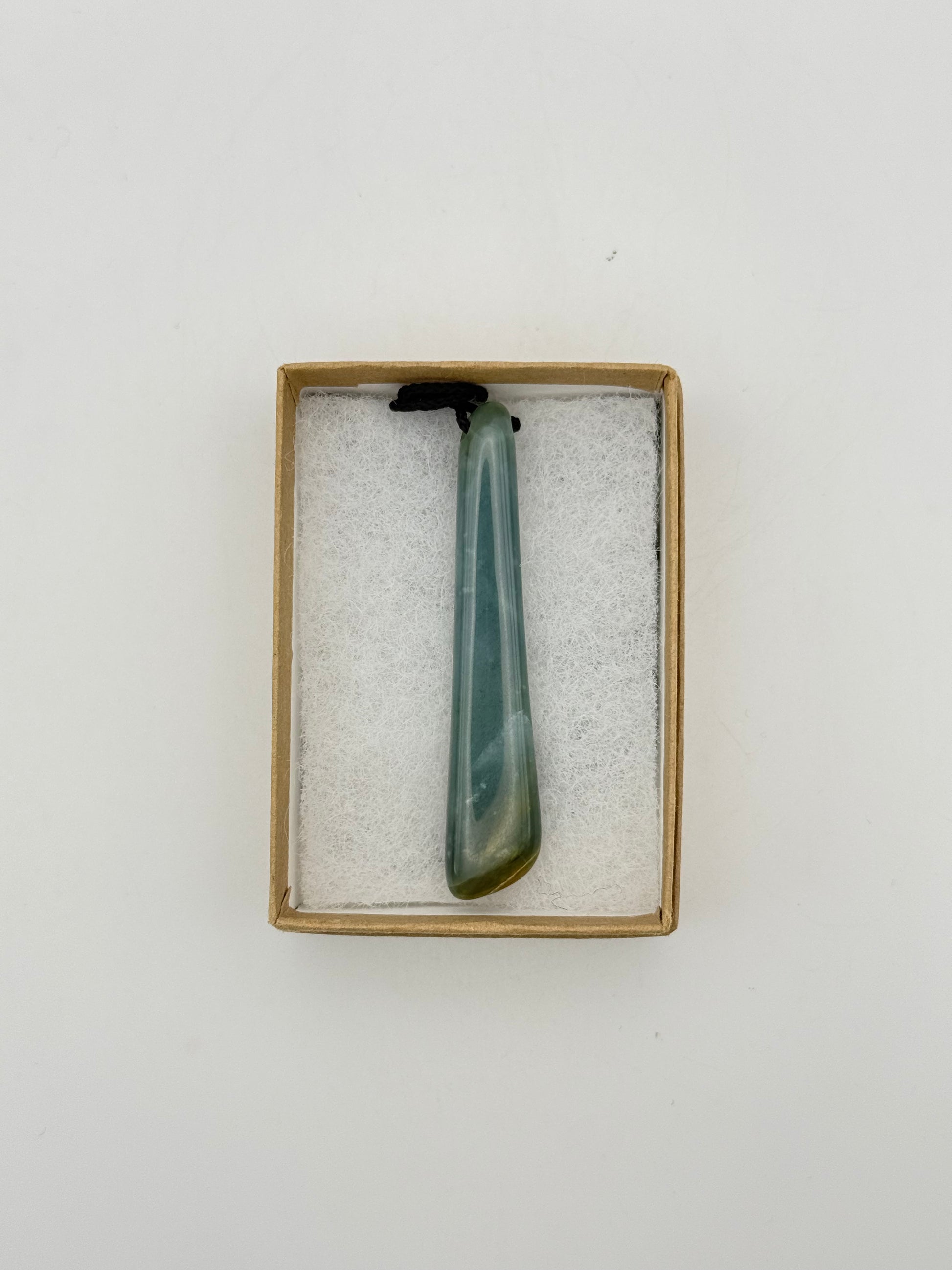 Green Jade pendant with string necklace.