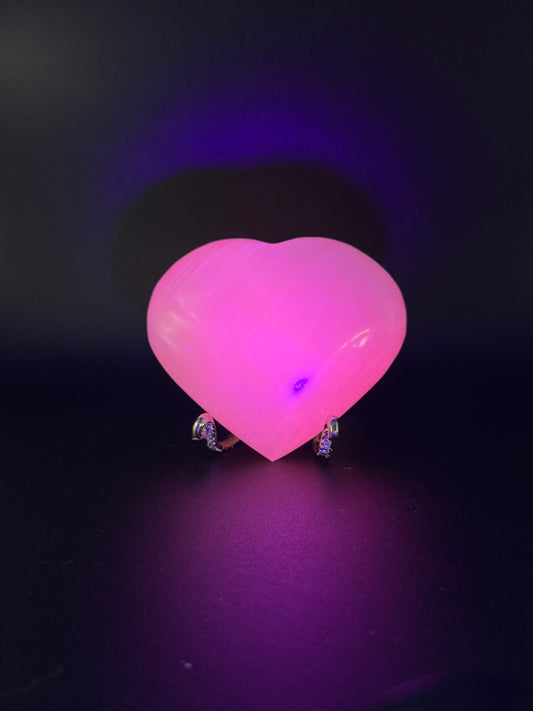 Polished pink calcite heart. Pink calcite glows under uv light.