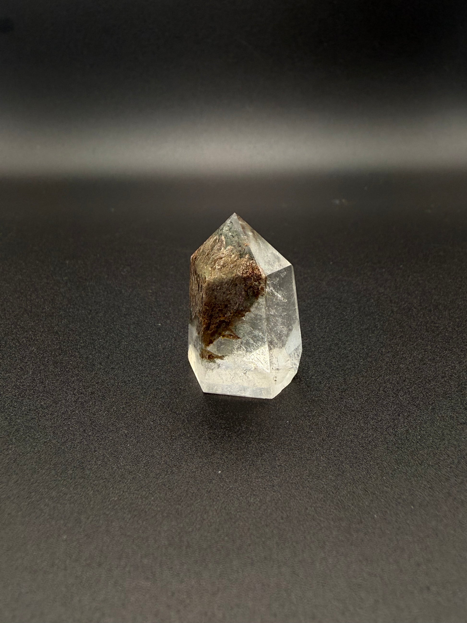 Polished garden quartz crystal tower with six sides.