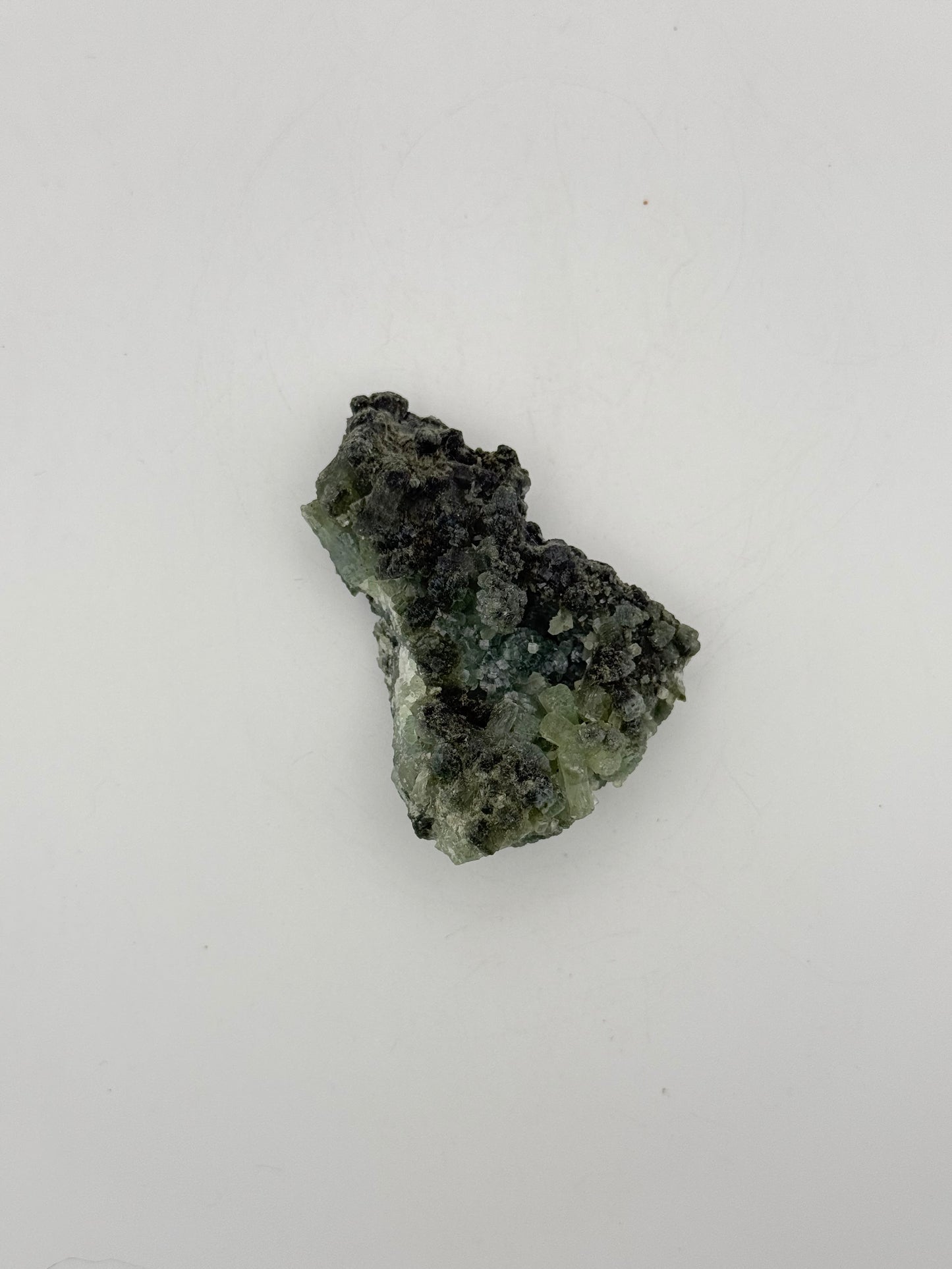 Raw Prehnite specimen with amazing green color.