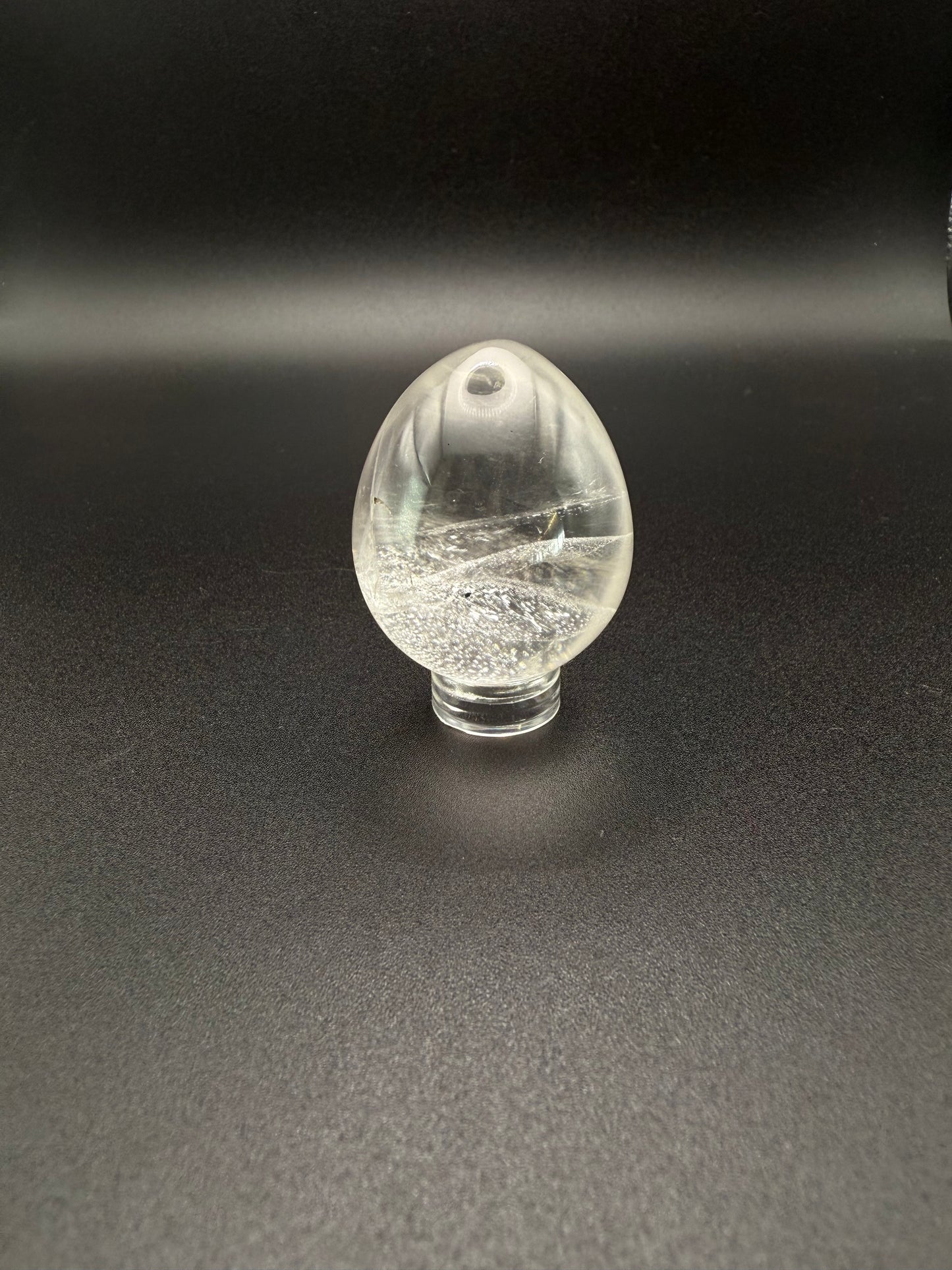 Clear quartz polished crystal in the shape of an egg.