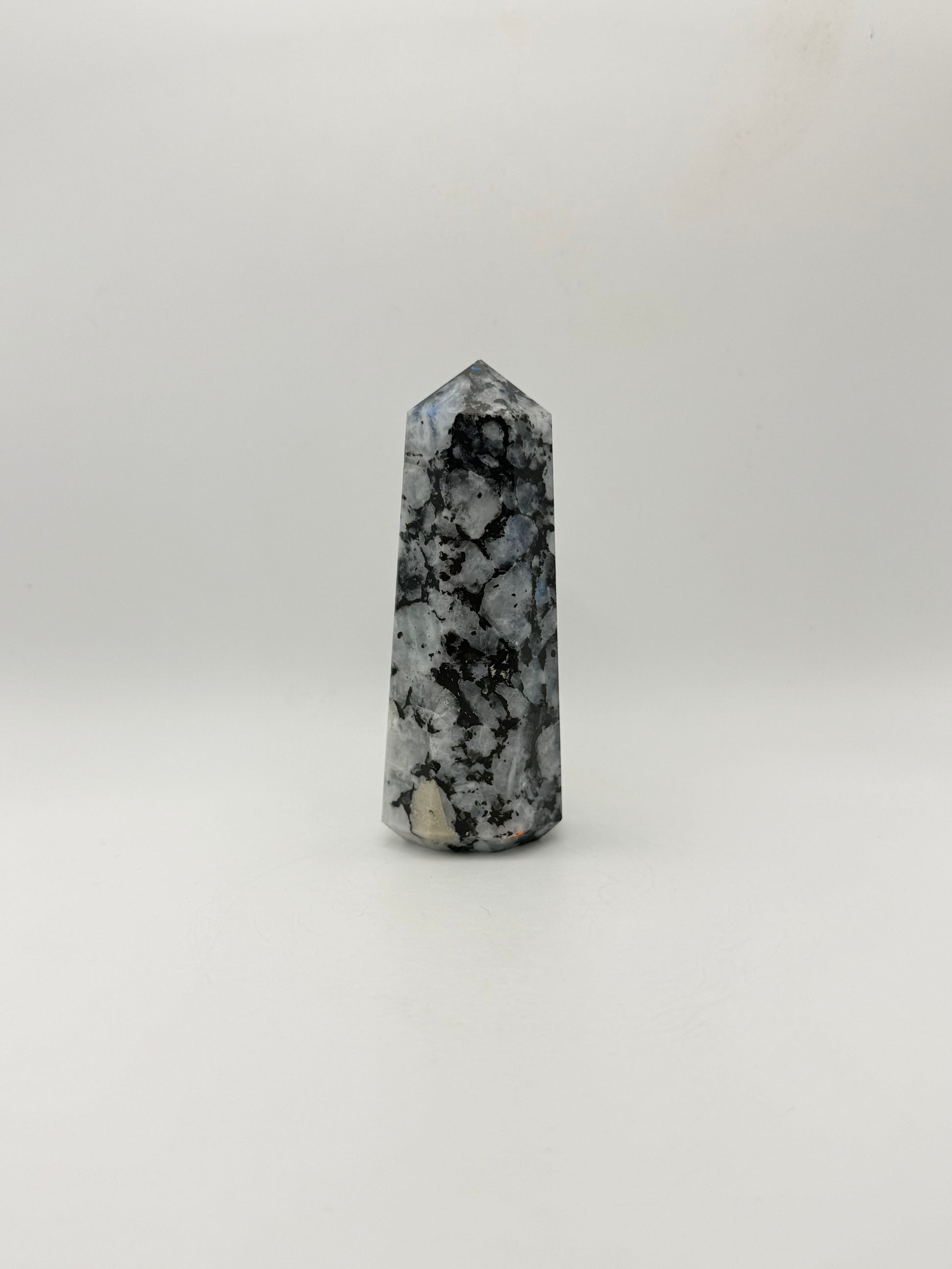 Polished rainbow moonstone tower with nice flashes of blue.