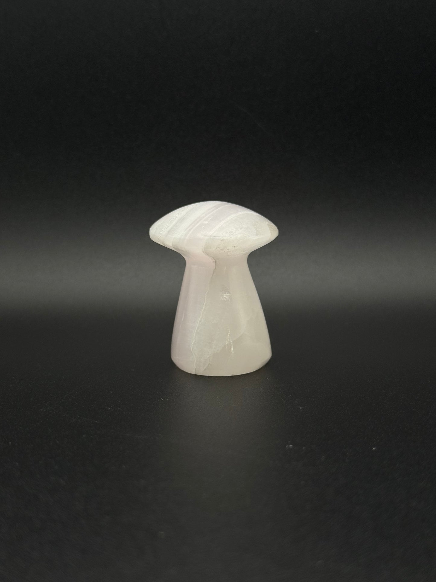 Polished pink calcite mushroom. Pink calcite glows under uv light.