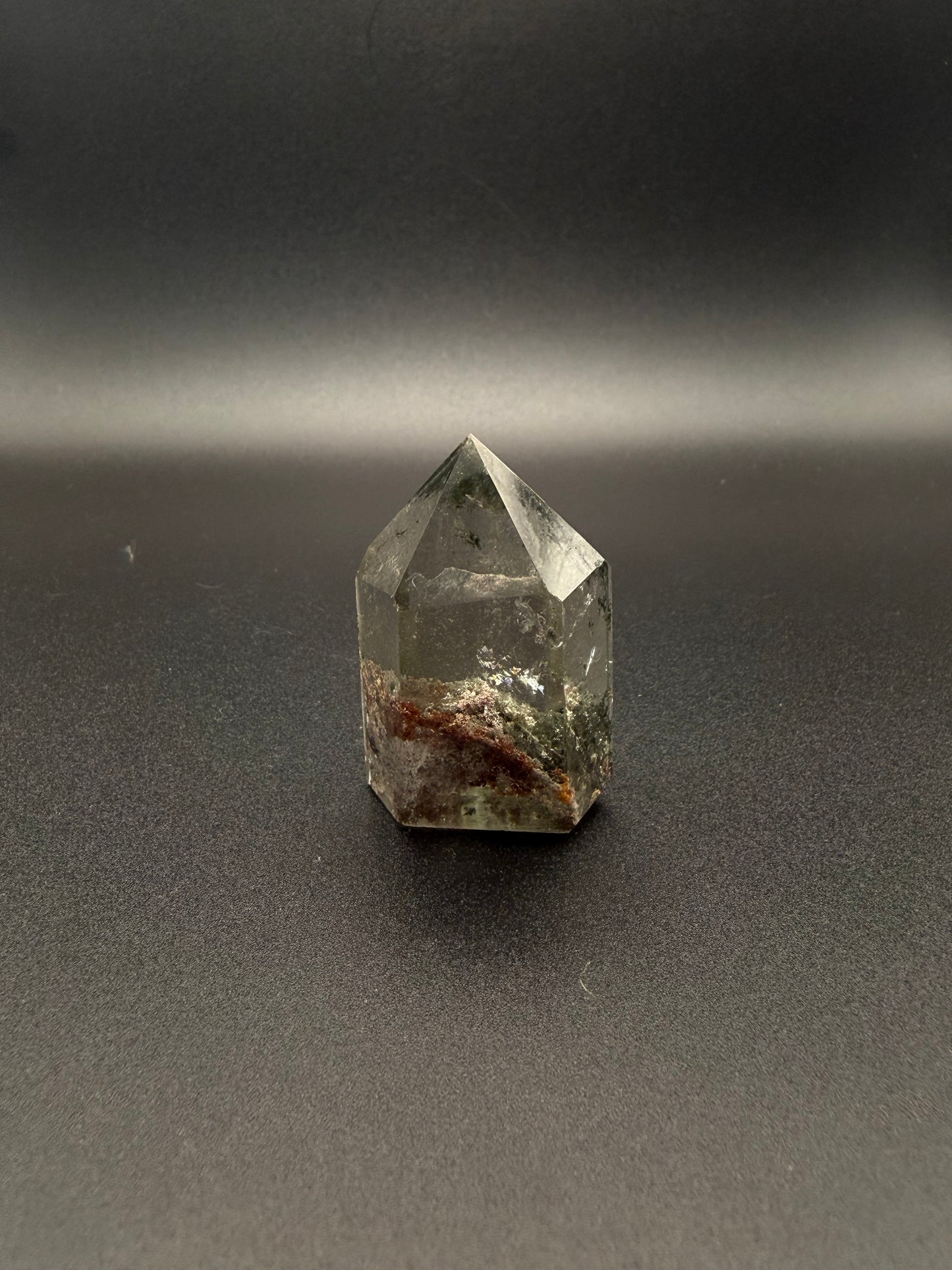 Polished garden quartz crystal tower with six sides.