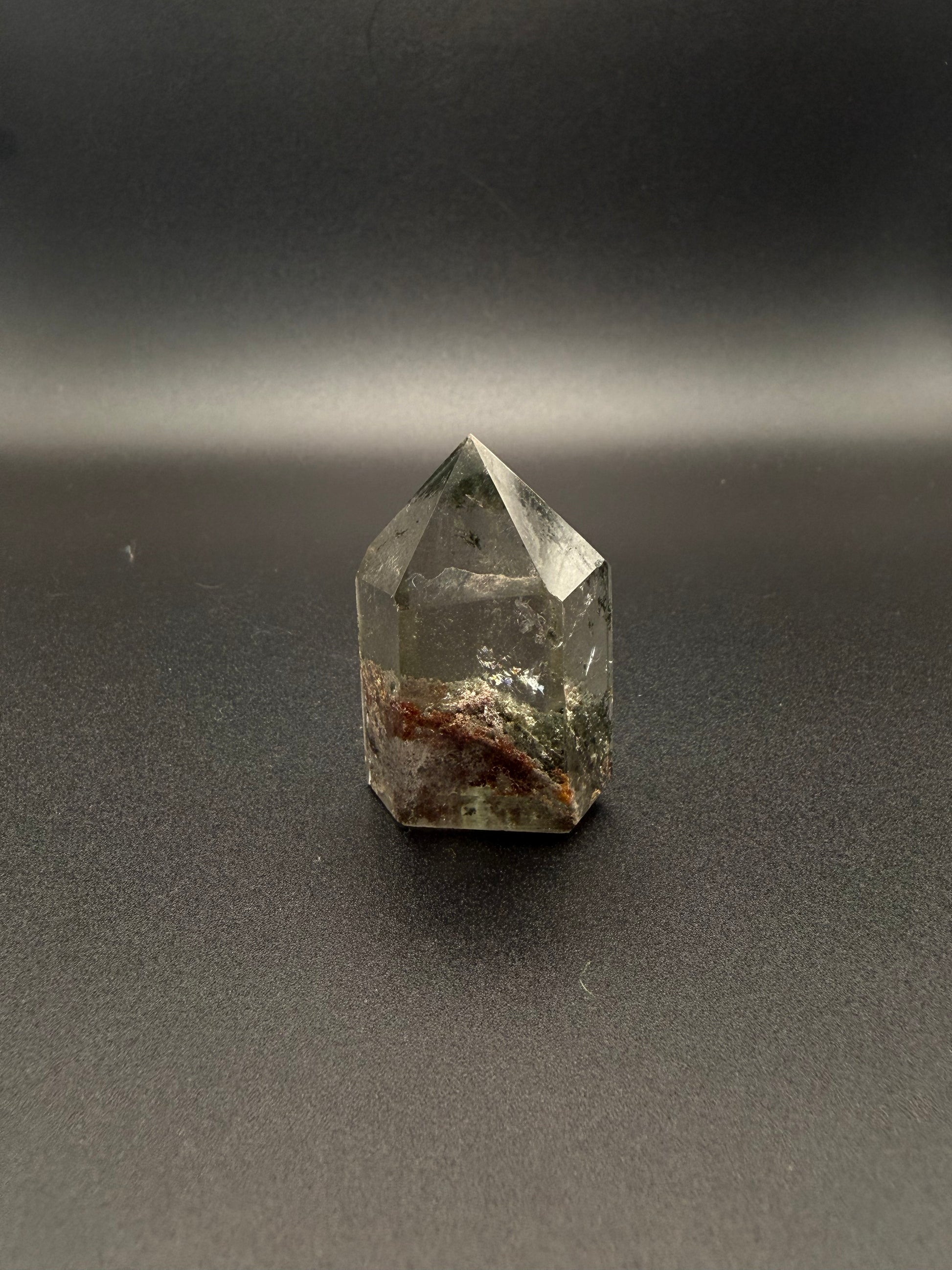 Polished garden quartz crystal tower with six sides.