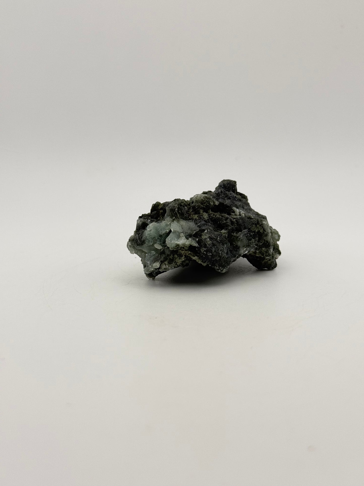 Raw Prehnite specimen with amazing green color.