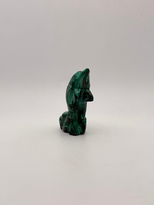 Polished malachite dolphin carving.