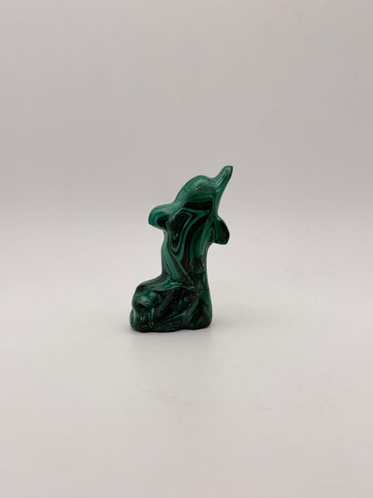 Polished malachite dolphin carving.