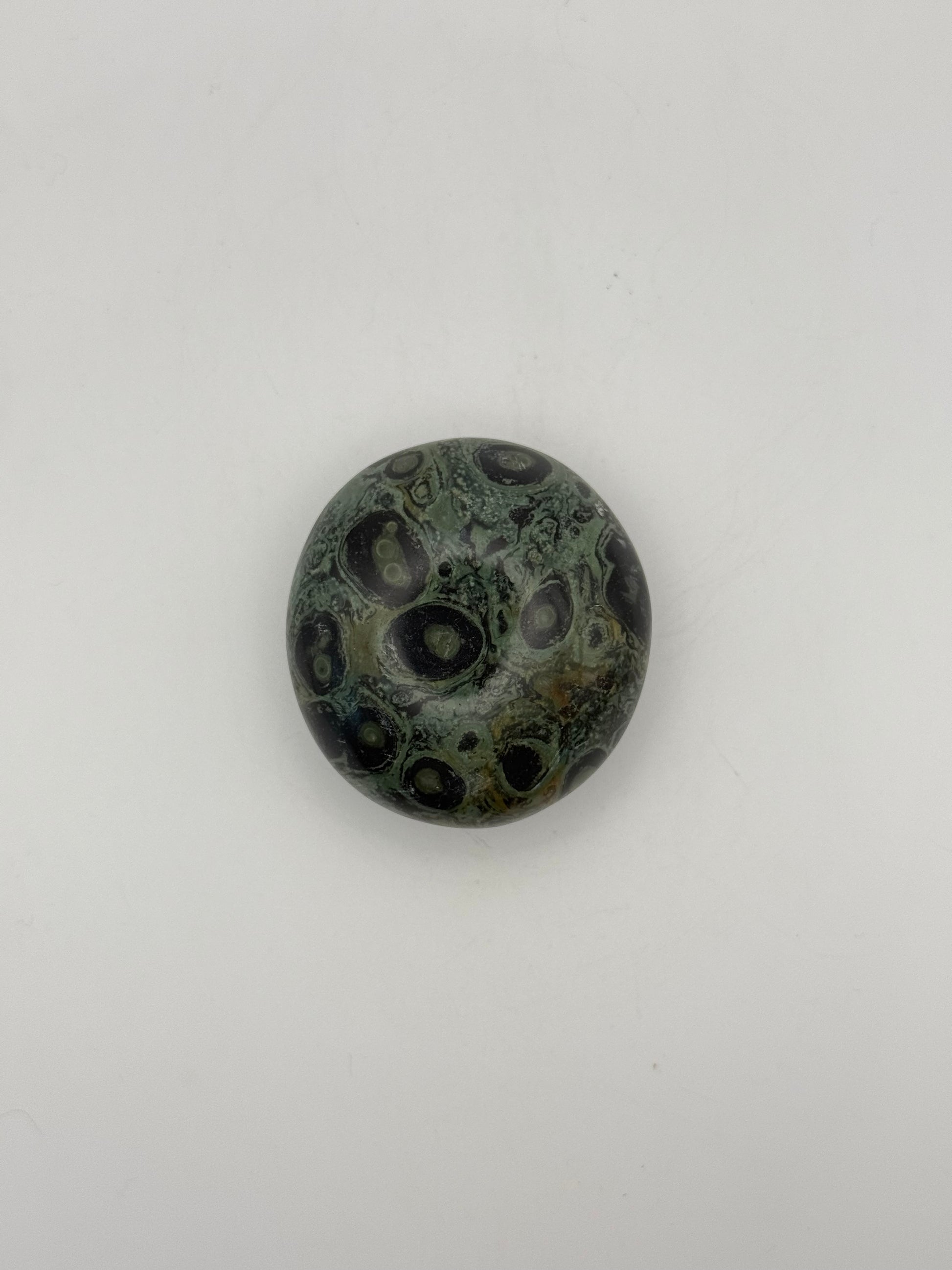 Polished kambaba jasper palm stone.