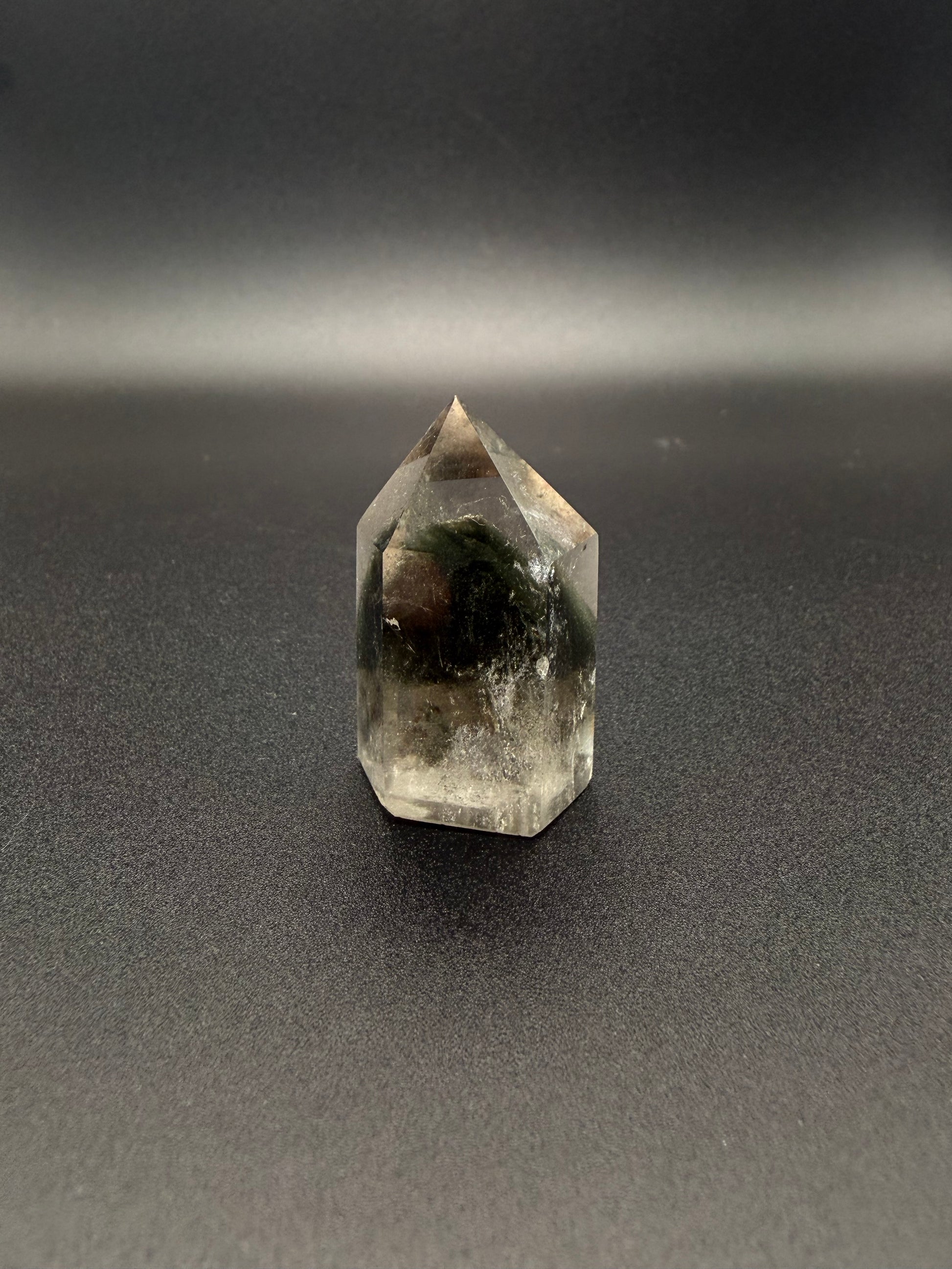 Polished garden quartz crystal tower with six sides.