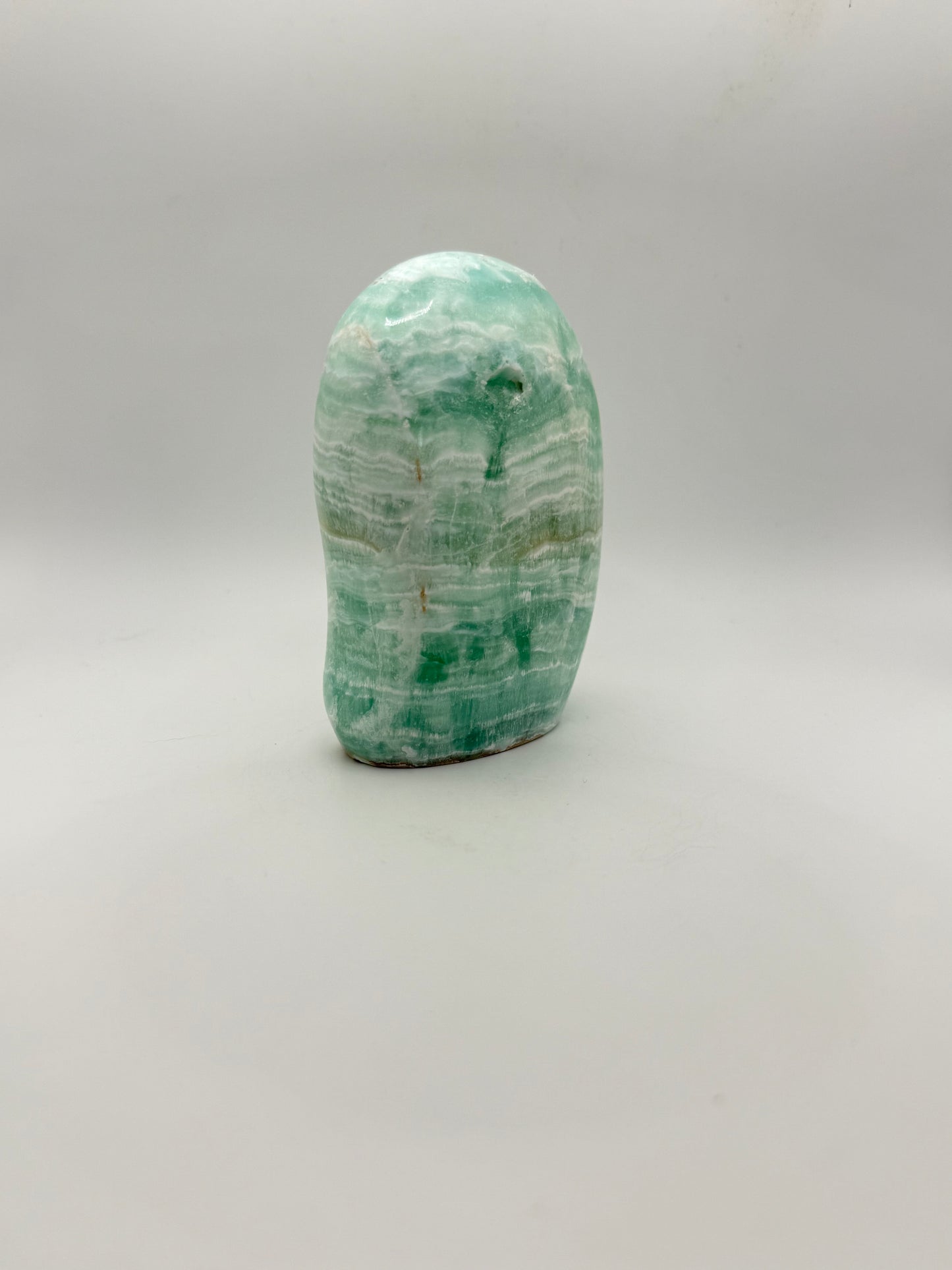 Caribbean calcite polished crystal free form in the shape of a dome.