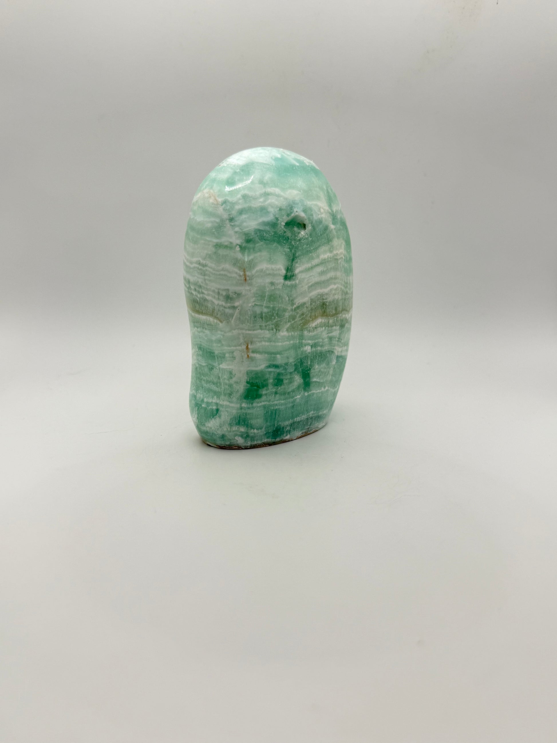 Caribbean calcite polished crystal free form in the shape of a dome.