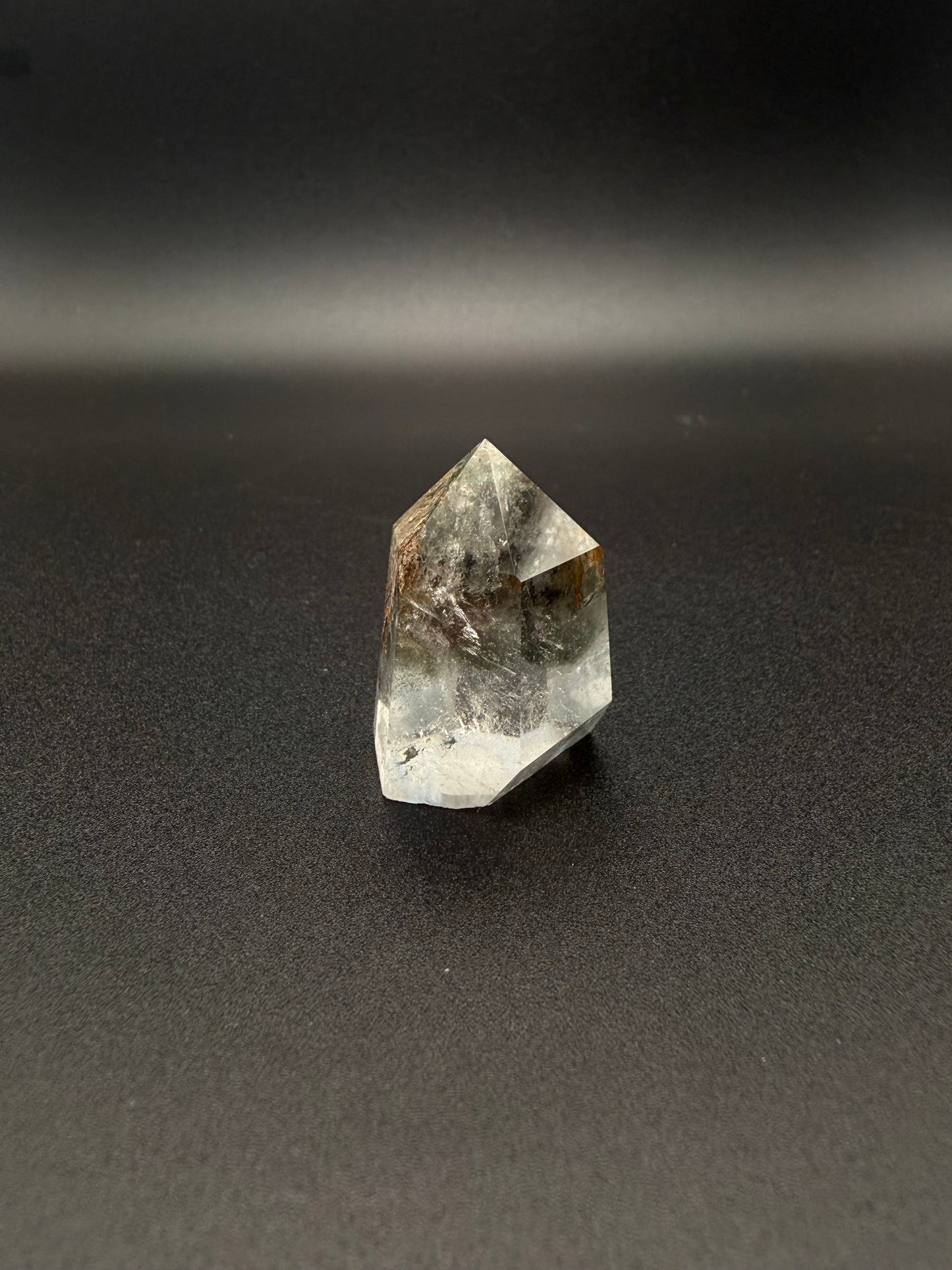 Polished garden quartz crystal tower with six sides.