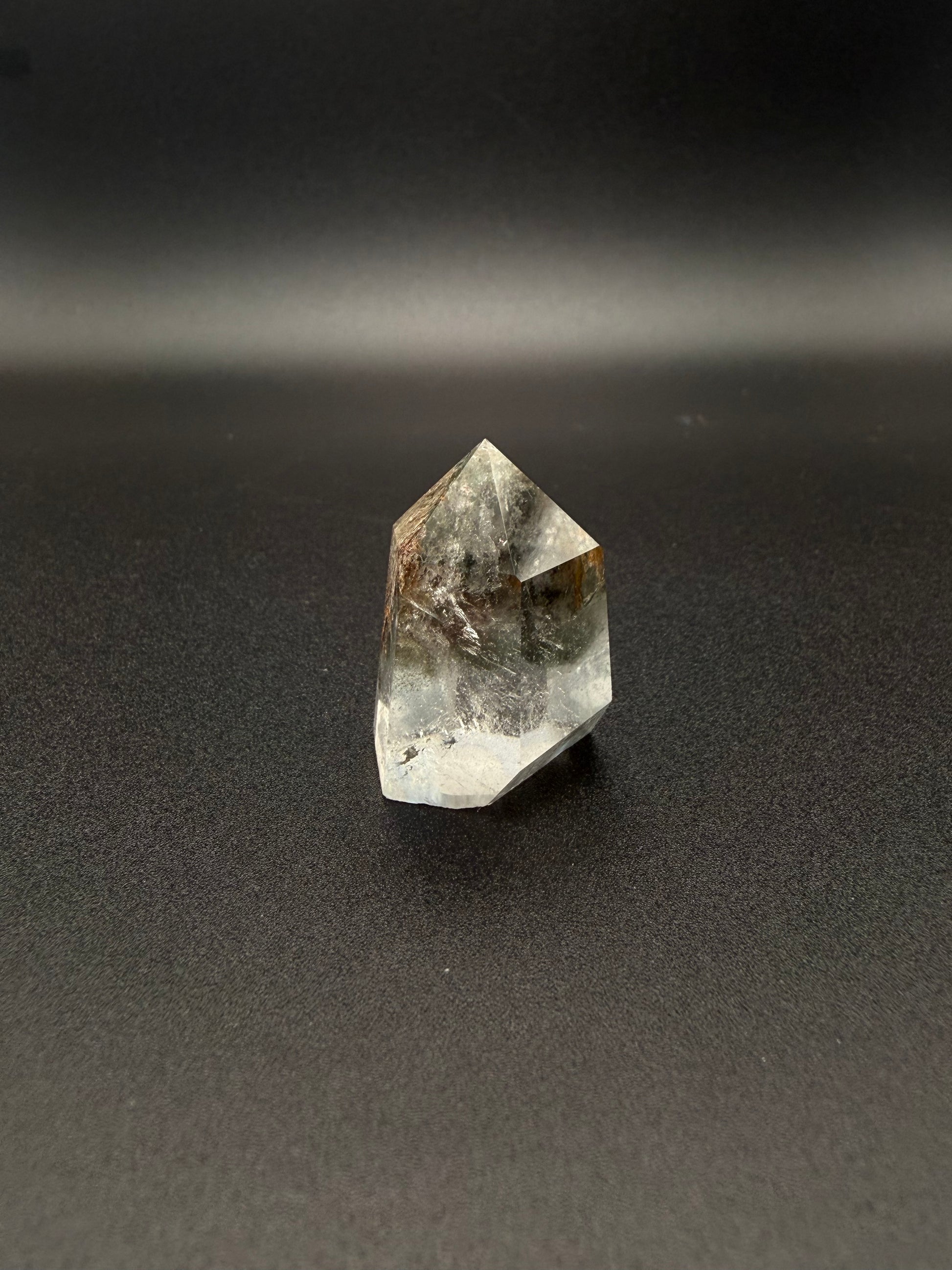 Polished garden quartz crystal tower with six sides.