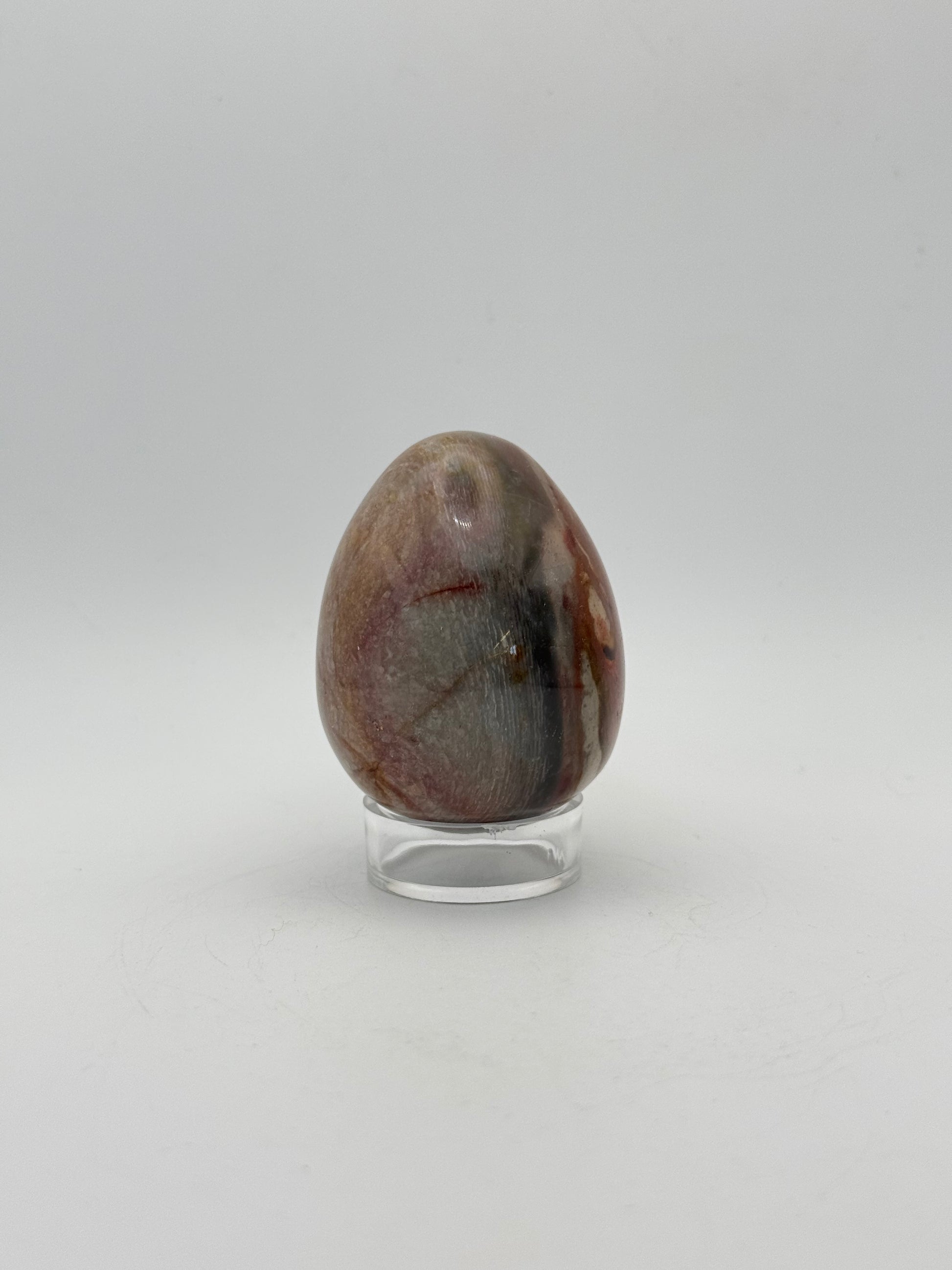 Polished polychrome jasper shaped into an egg.