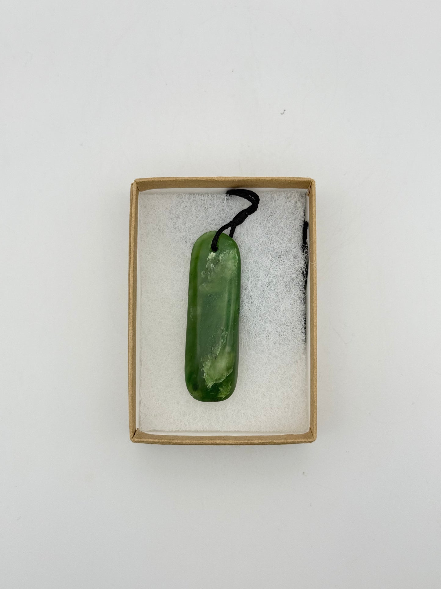Green Jade pendant with string necklace.