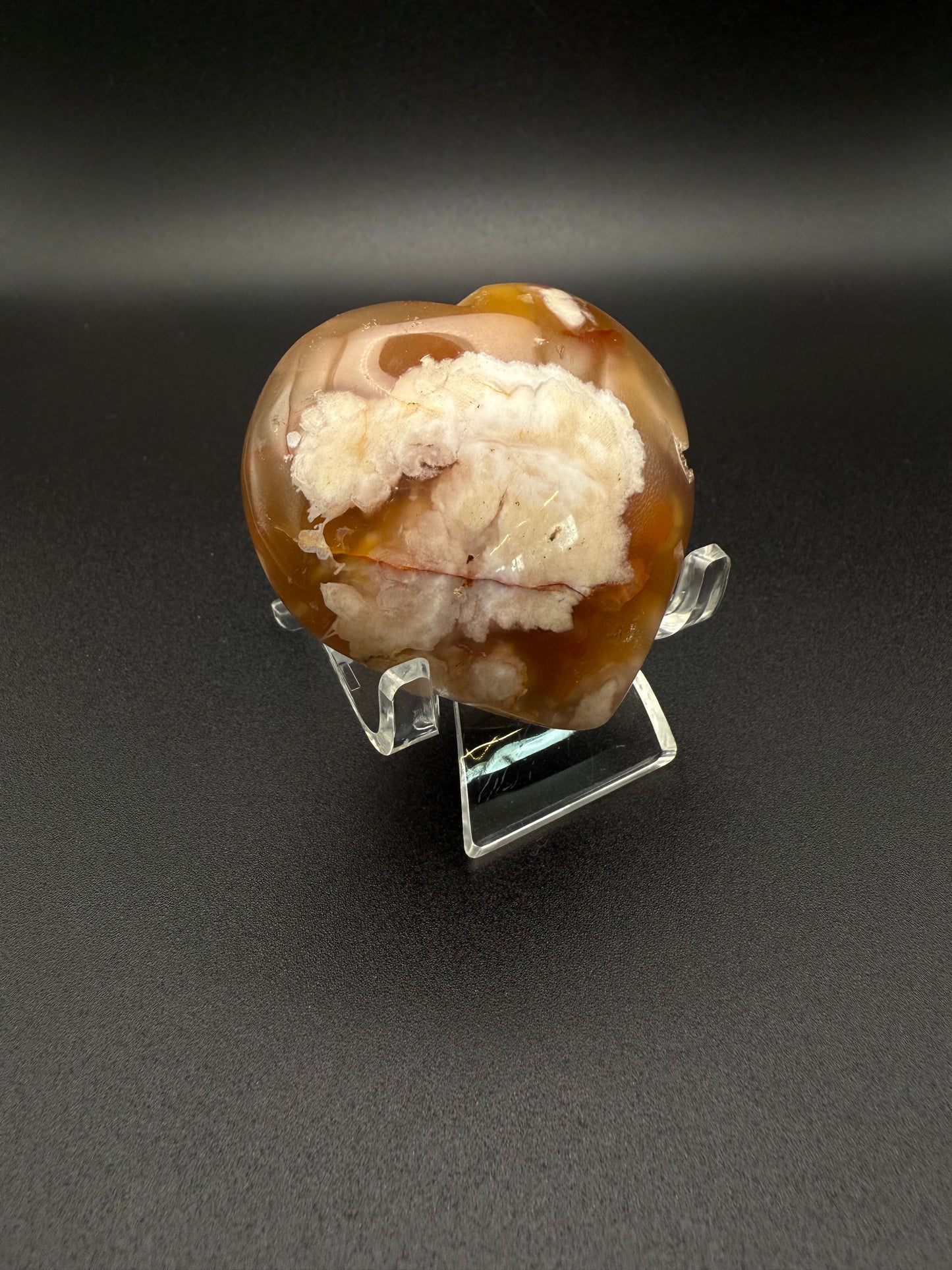 Flower Agate polished crystal in the shape of a heart.