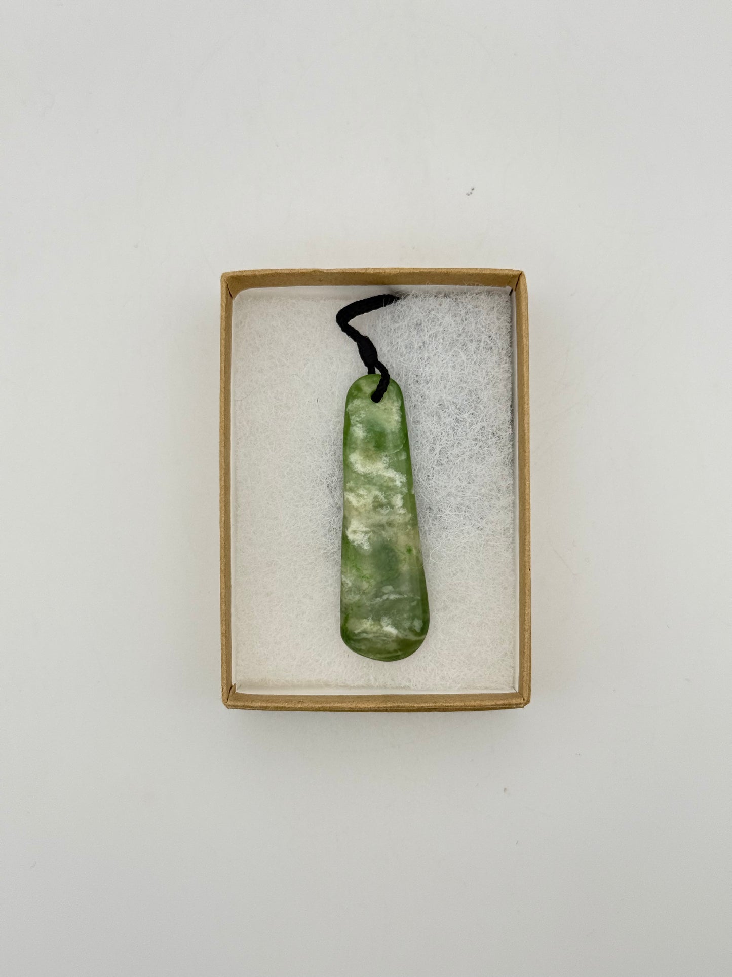 Green Jade pendant with string necklace.