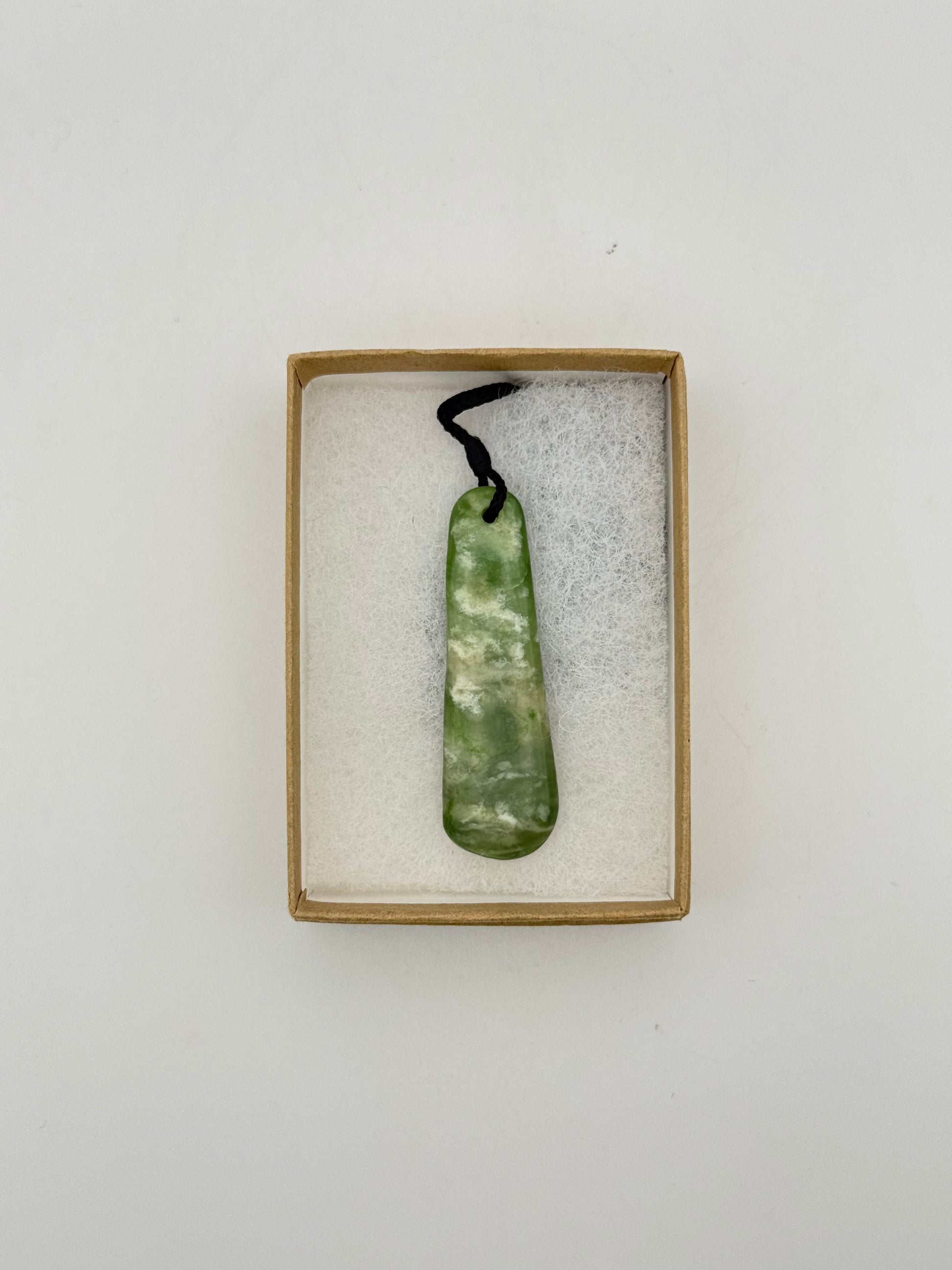 Green Jade pendant with string necklace.