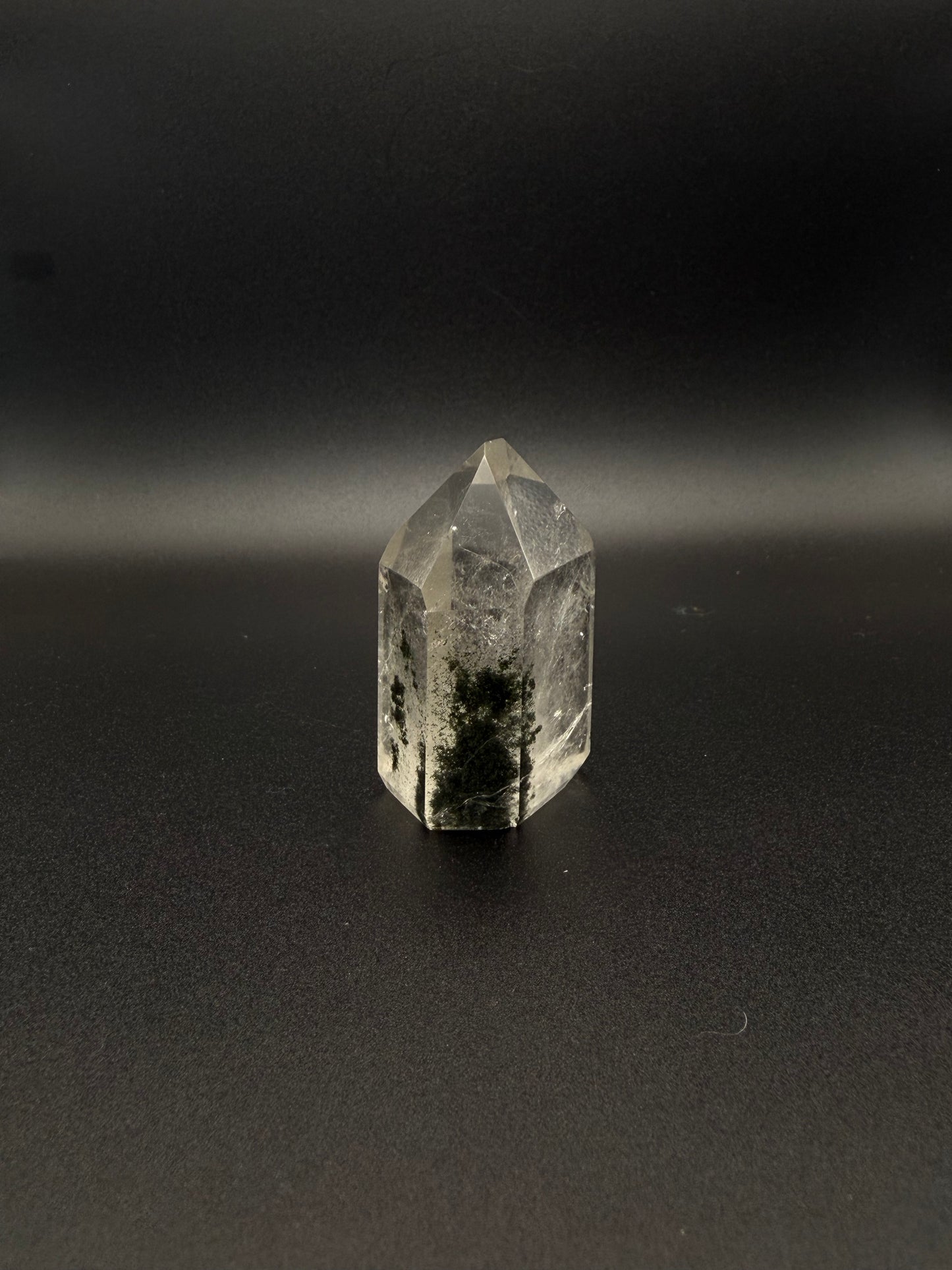 Polished garden quartz crystal tower with six sides.