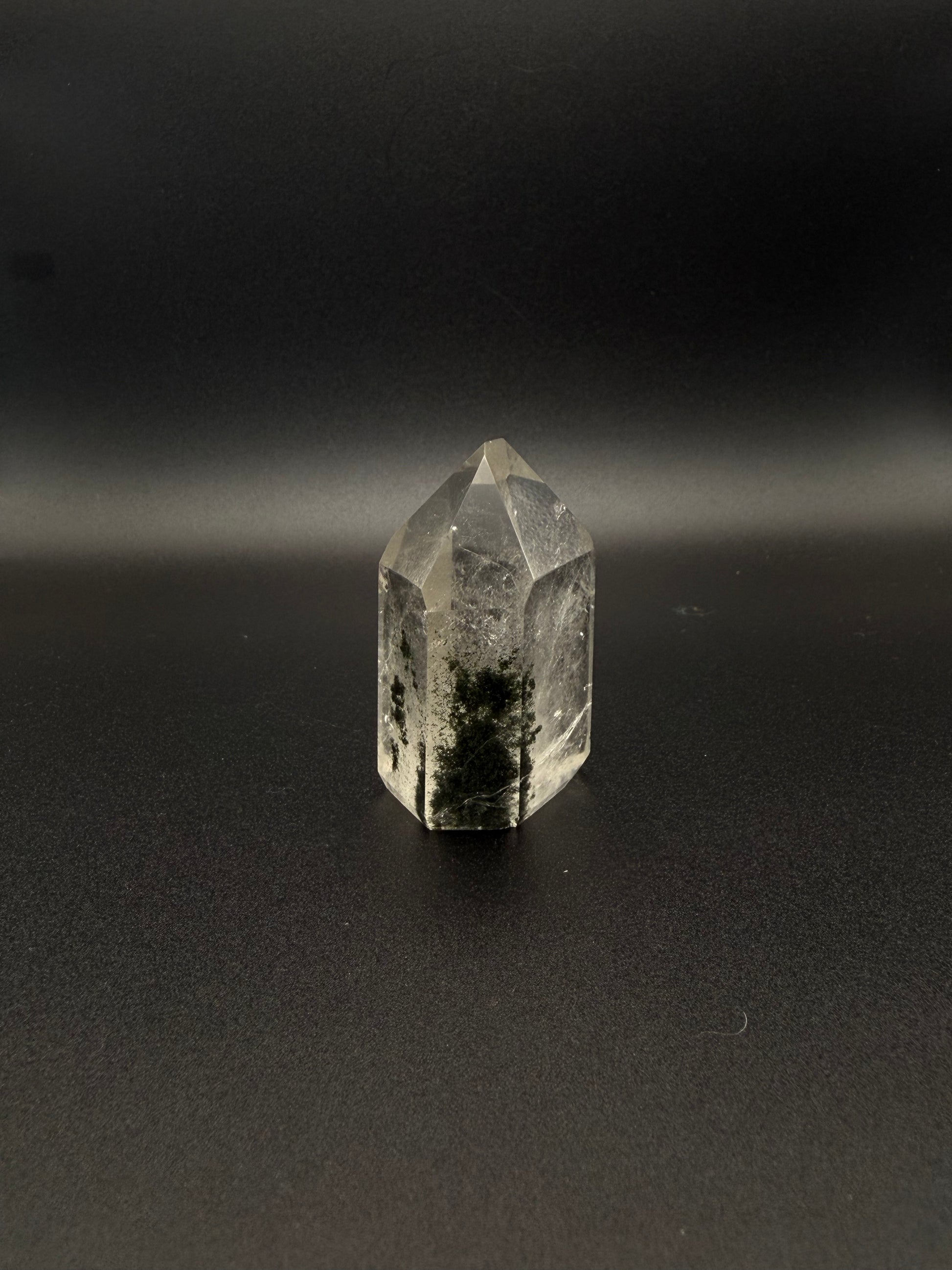 Polished garden quartz crystal tower with six sides.