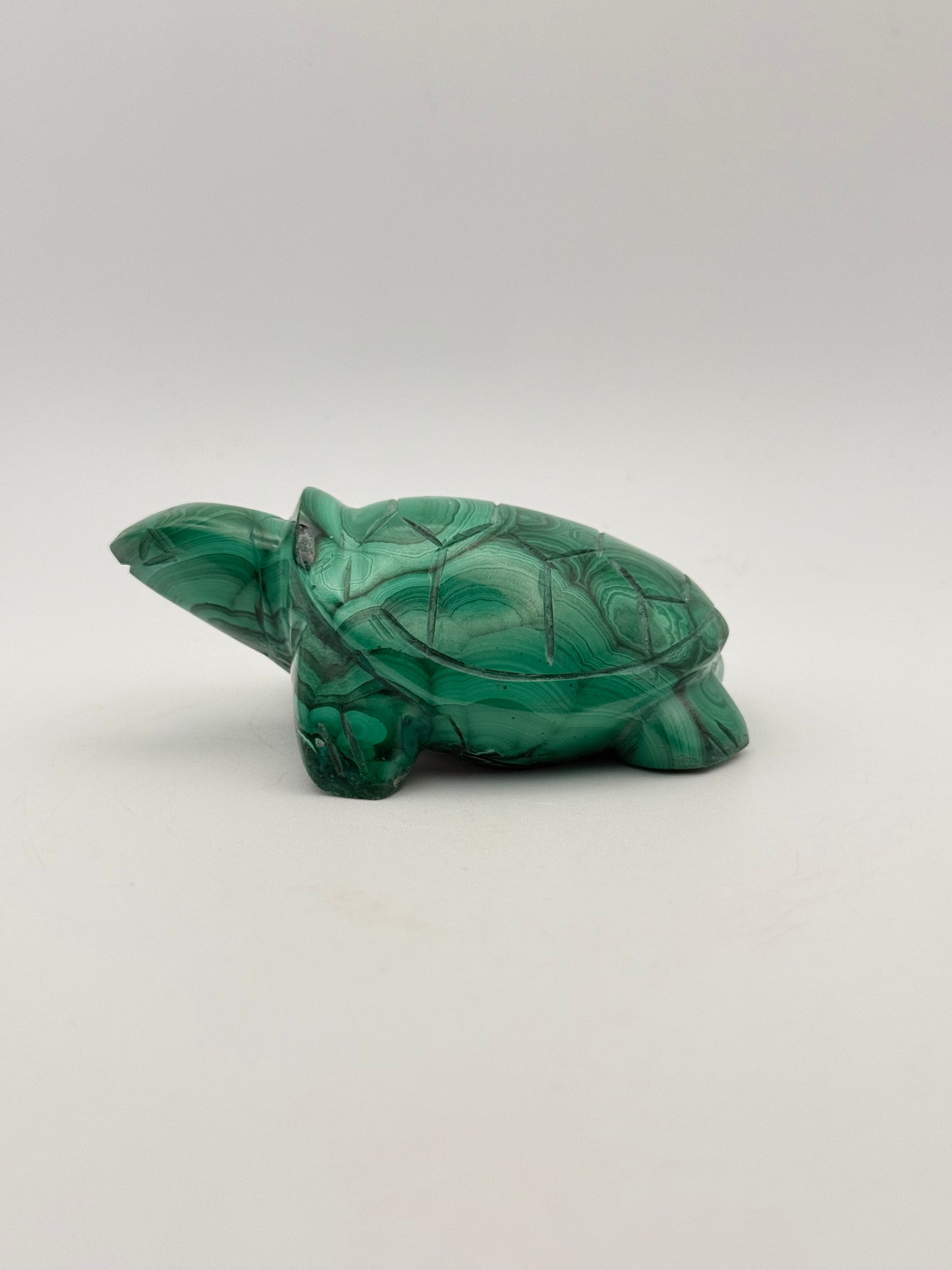 Vibrant green malachite stone carving of a turtle.
