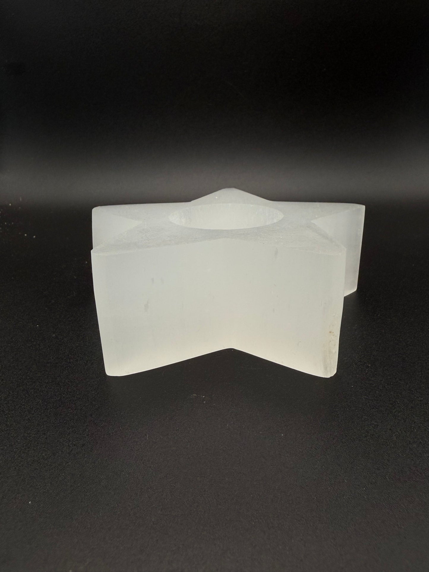 Star-shaped selenite candle holder.