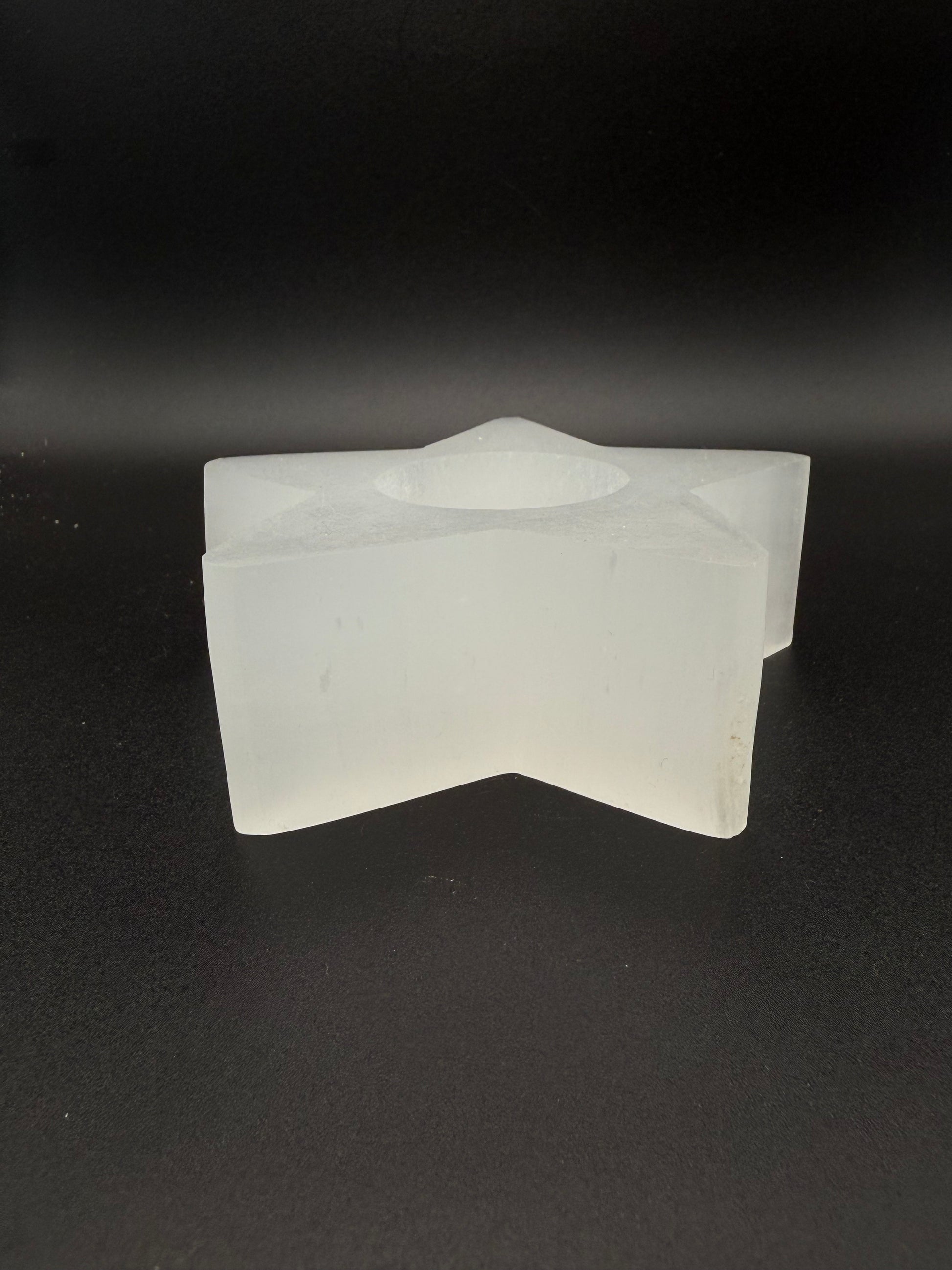 Star-shaped selenite candle holder.