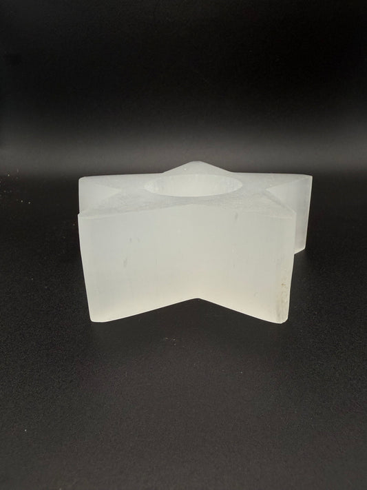 Star-shaped selenite candle holder.