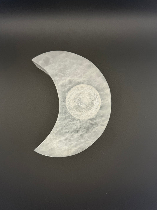 Selenite candle holder in the shape of a moon.